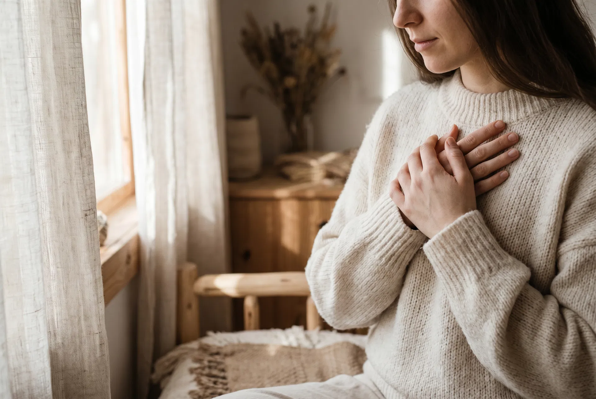 Hands resting on chest in a gesture of self-soothing
