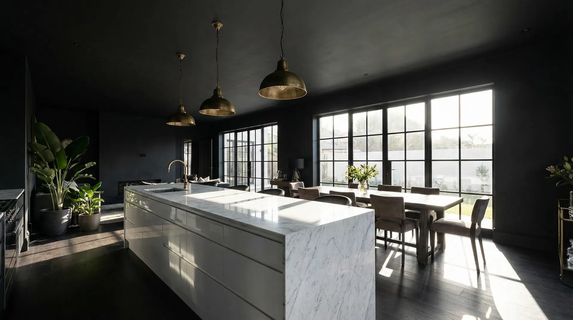 Dramatic open-plan kitchen with deep charcoal matte walls and white marble island