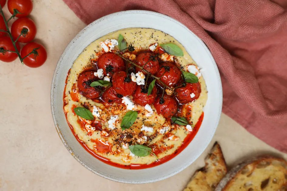 Silky Feta Polenta with Roasted Harissa Cherry Tomatoes — a plant-based Italian recipe by BOSH!