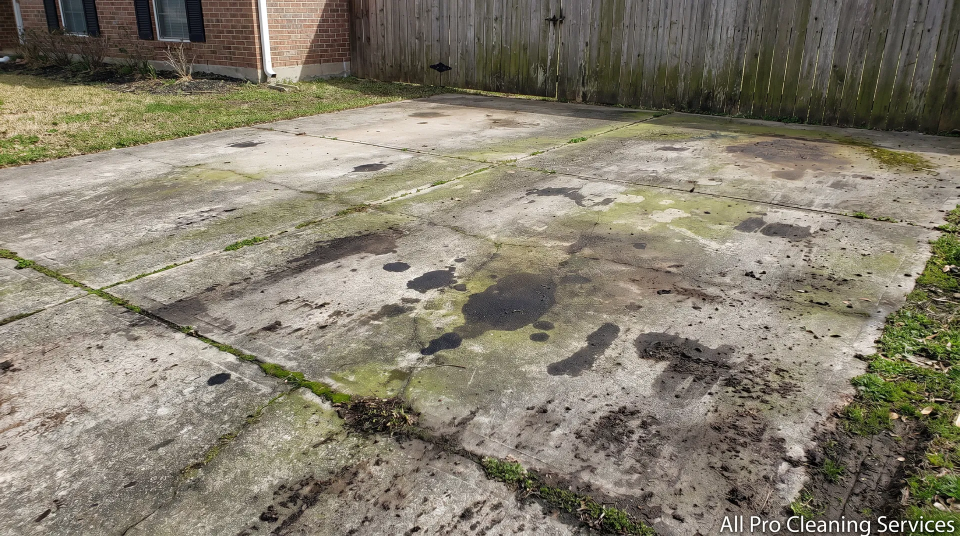 All Pro Cleaning Services - dirty stained driveway before power washing - Hutchinson KS