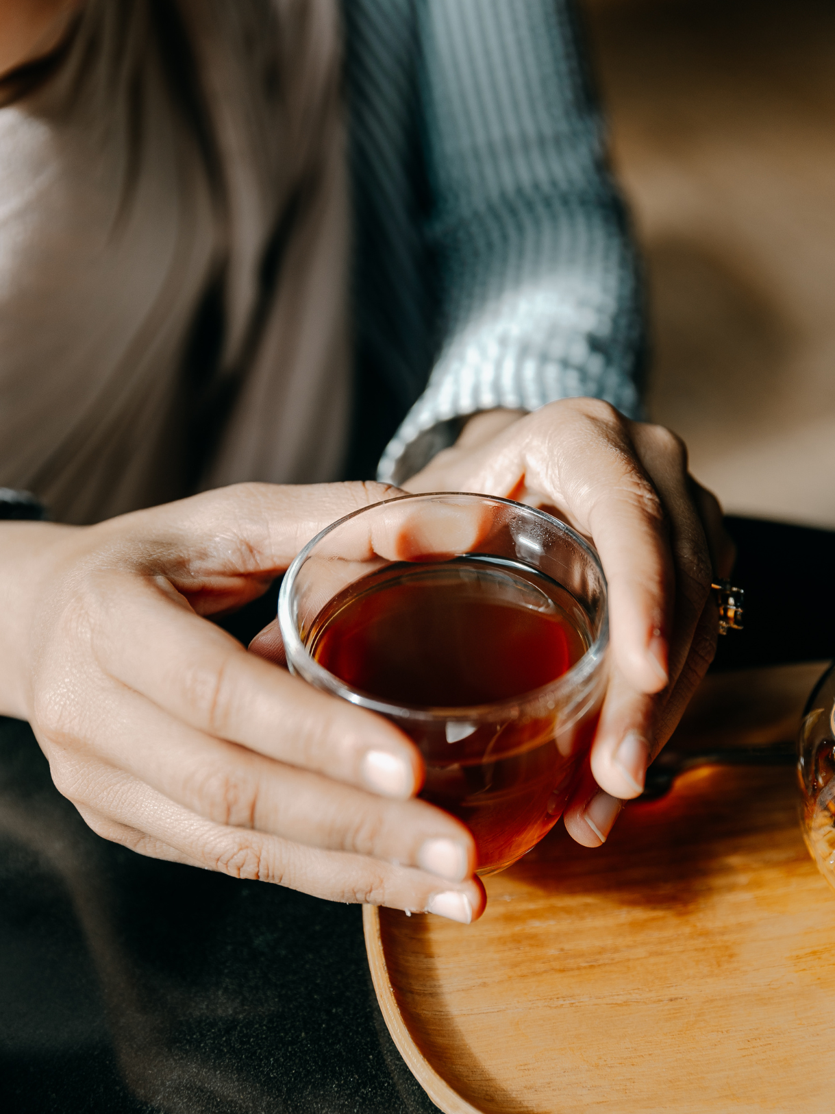 Hands holding tea cup - intimate tea moment