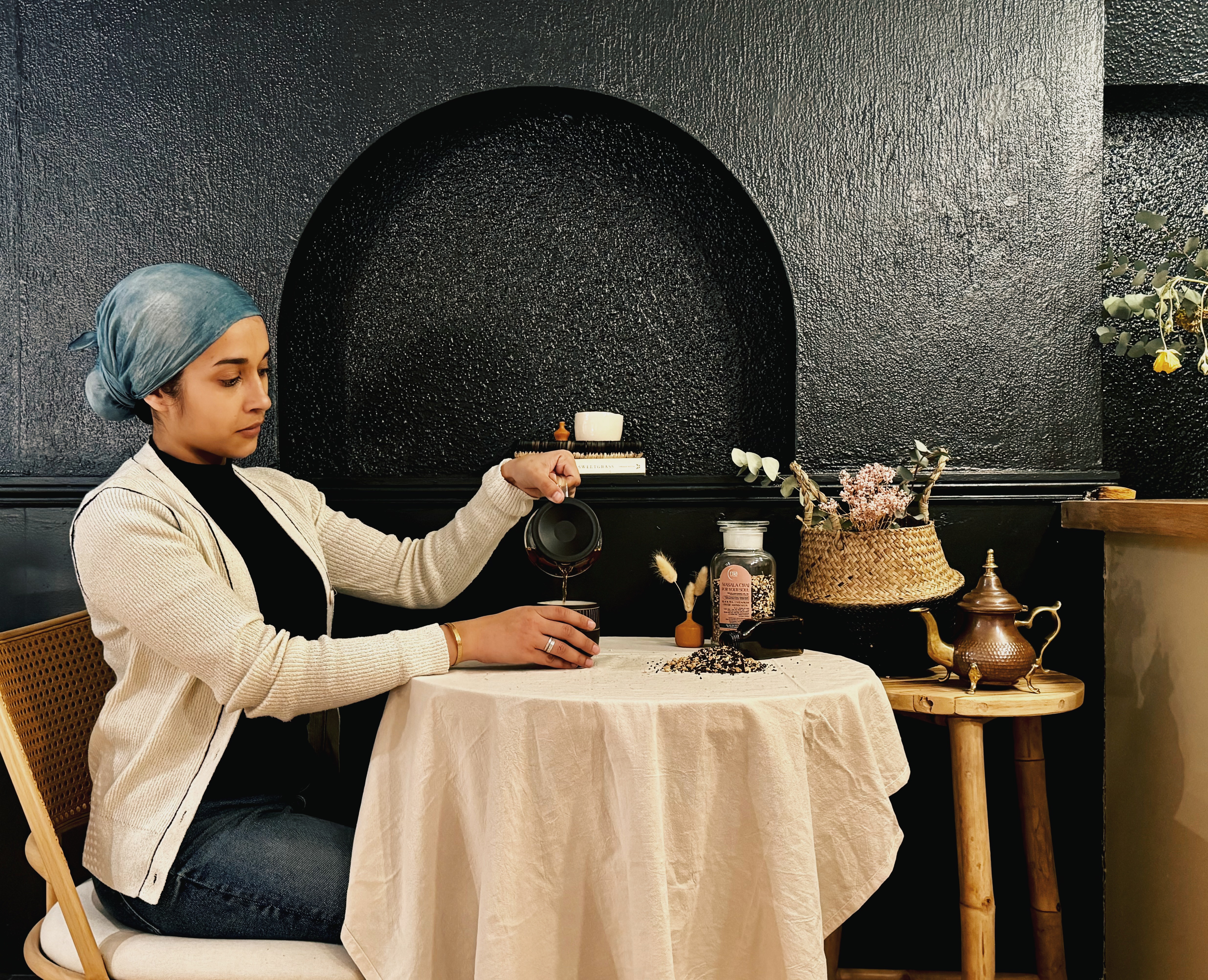 Mahin, Founder of Nia Botanica, performing tea ritual