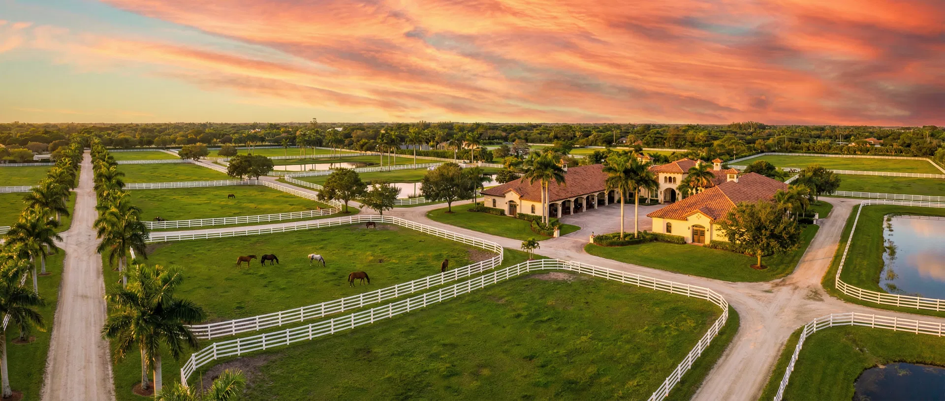 Beautiful South Florida horse farm with green pastures and white fences in Davie, FL