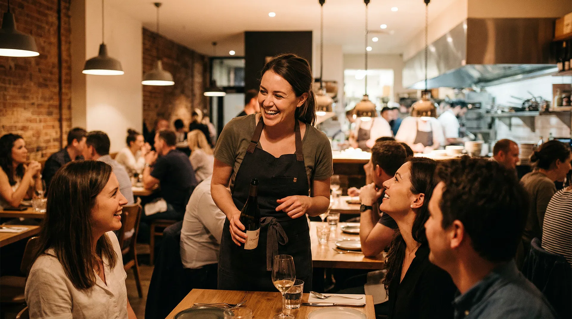 Smiling restaurant server fully engaged with guests at the table