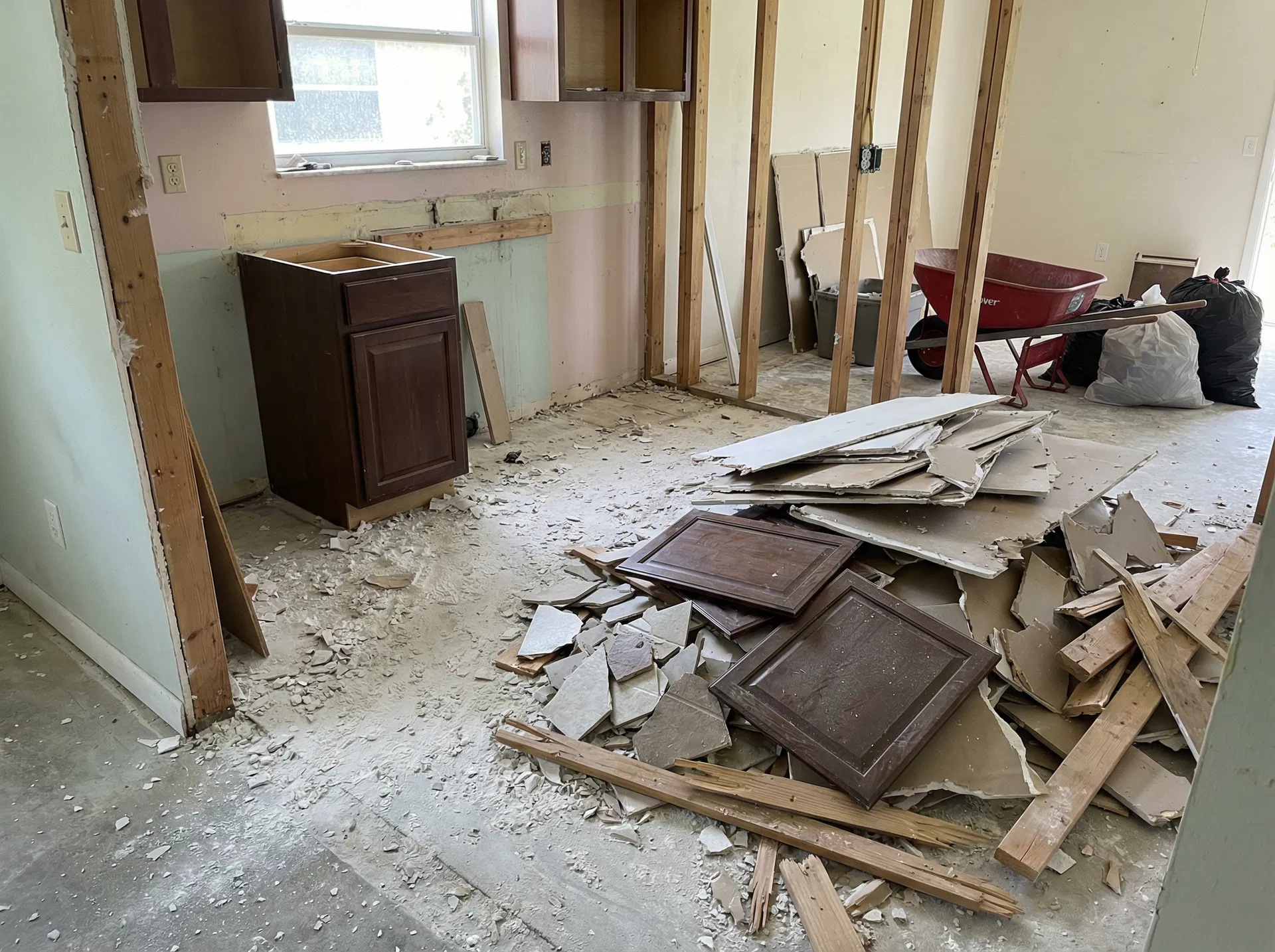 Kitchen renovation debris with drywall old cabinets and construction waste in Dr Phillips Orlando