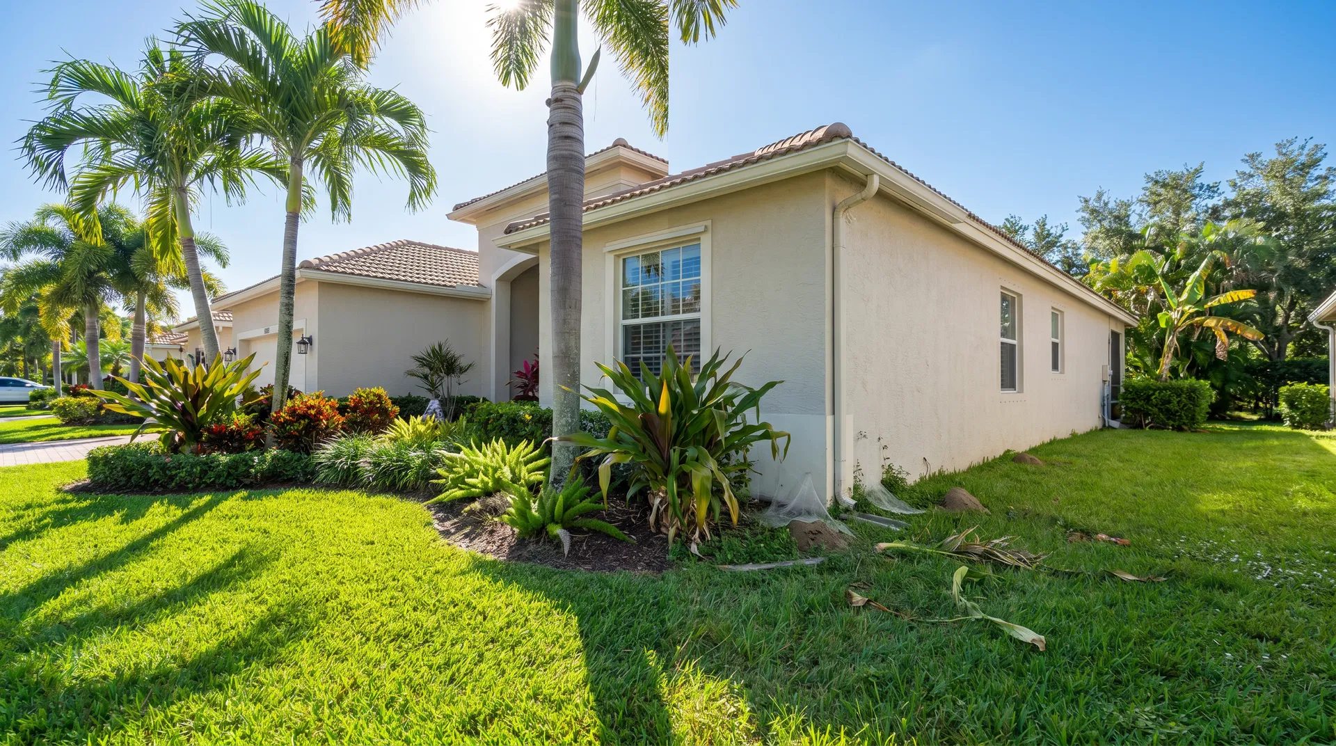 Well-maintained South Florida home with tropical landscaping, representing the value of ongoing pest protection