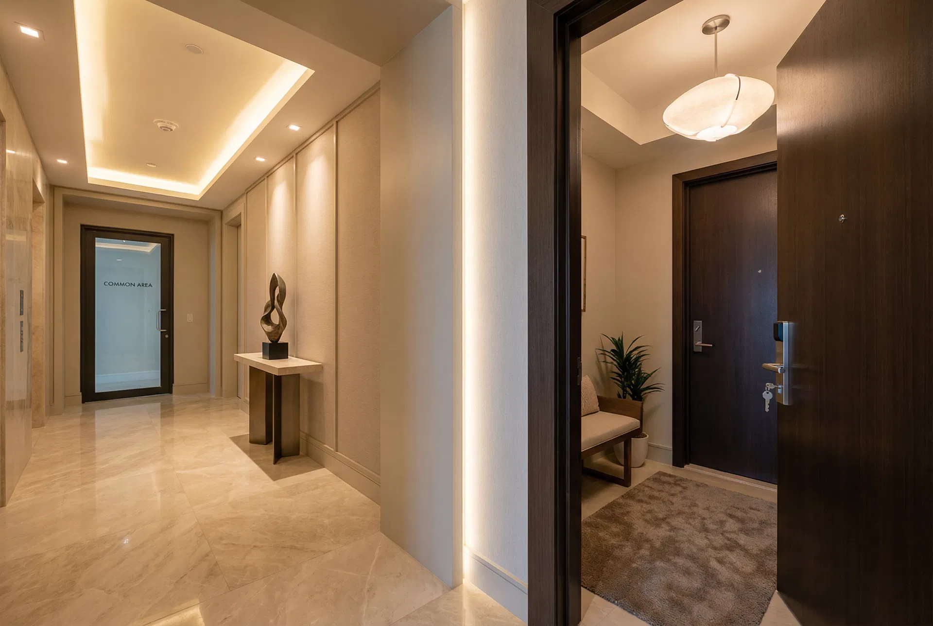 Condo hallway showing common area and unit entrance
