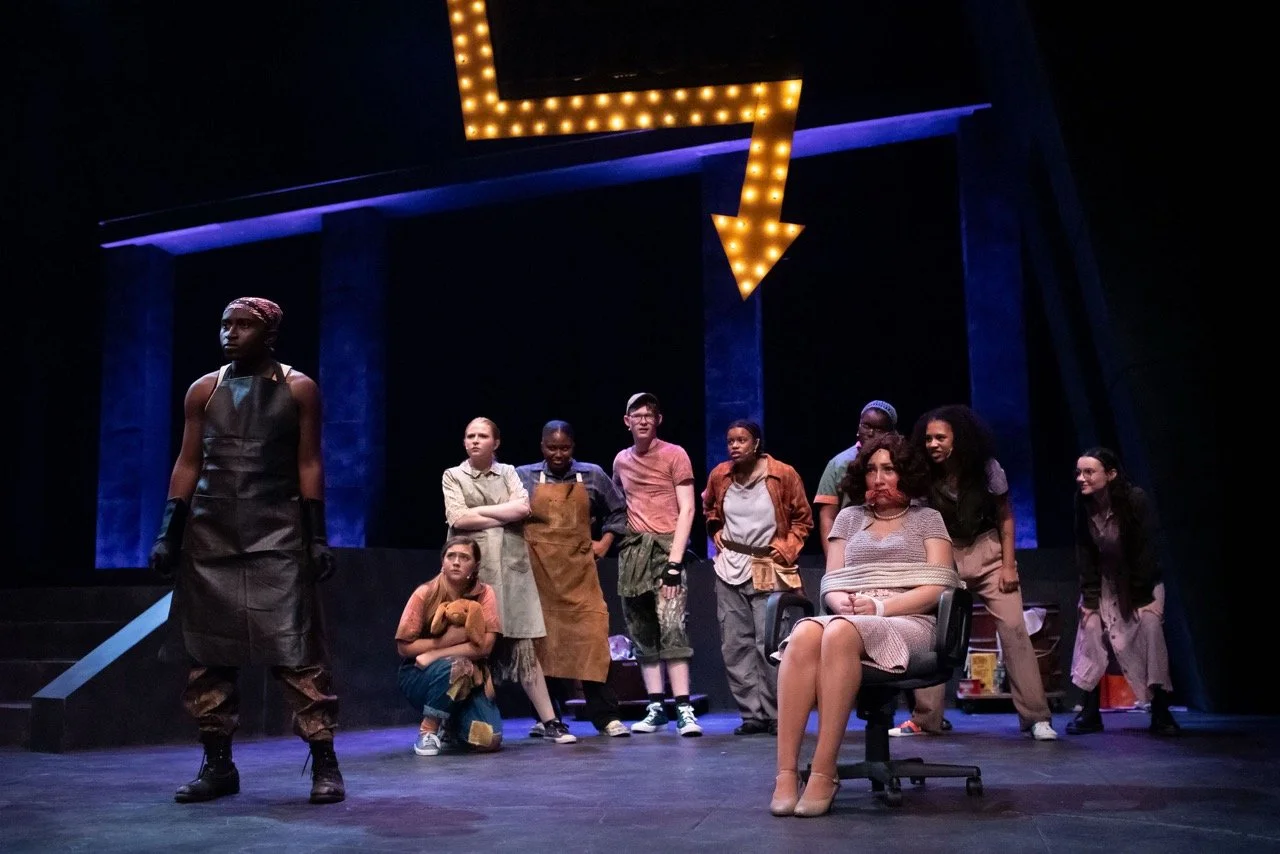 Urinetown - Scenic design by Brandon PT Davis. Gritty, industrial set with pipes, rusted metal, and dim lighting, reflecting a water-scarce dystopian society.