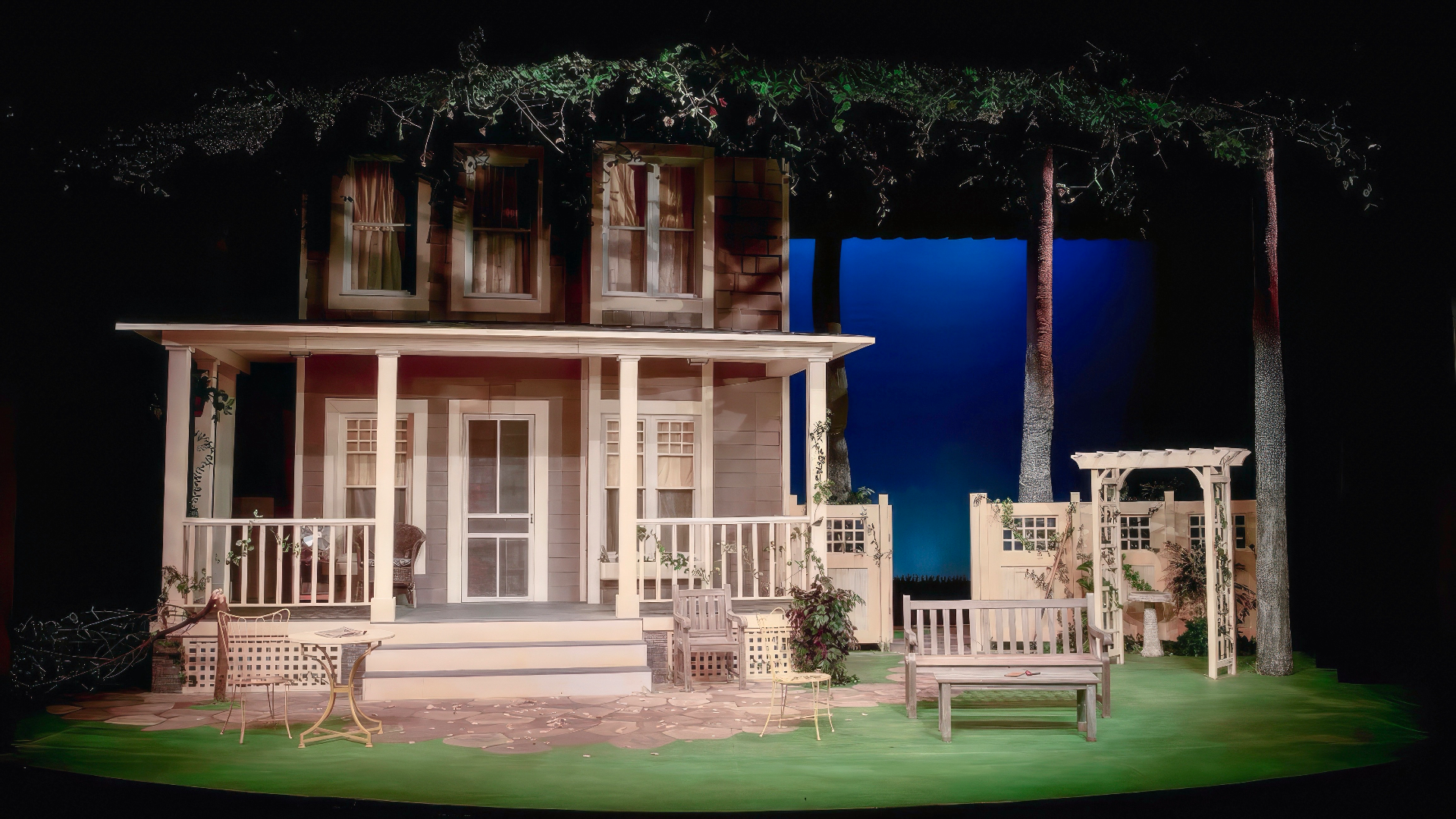 A Christmas Carol - Scenic design by Brandon PT Davis. Victorian London streetscape with cobblestones, gas lamps, and snow-dusted rooftops, evoking Dickensian charm.