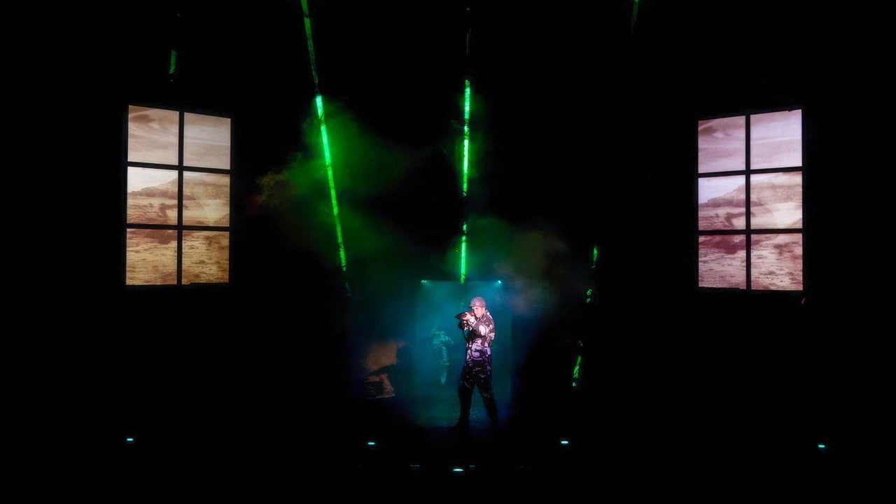 American Idiot - Scenic design by Brandon PT Davis. Industrial set with tall projection walls, punk rock club aesthetic, and 43 integrated TVs creating a dynamic, media-rich environment.
