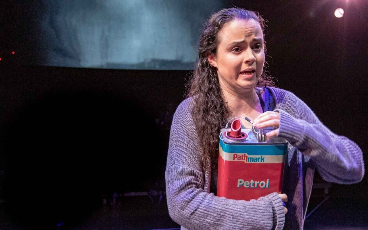 Parliament Square - Scenic design by Brandon PT Davis. A stark, urban landscape with imposing architectural elements, suggesting a tense political atmosphere.