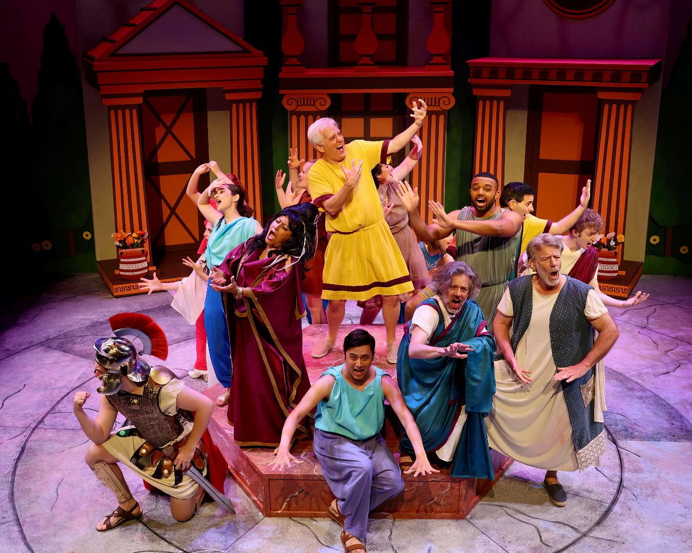 1776 - Scenic design by Brandon PT Davis. Colonial Assembly Room with period furnishings, warm wood tones, and dramatic lighting evoking Revolutionary America.