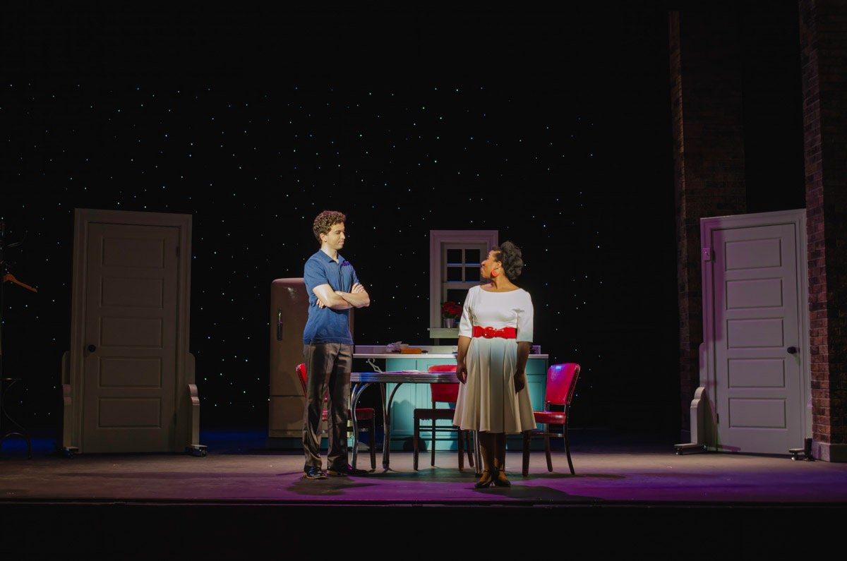 The Pajama Game - Scenic design by Brandon PT Davis. A vibrant 1950s pajama factory with industrial machinery, bright colors, and a lively atmosphere.