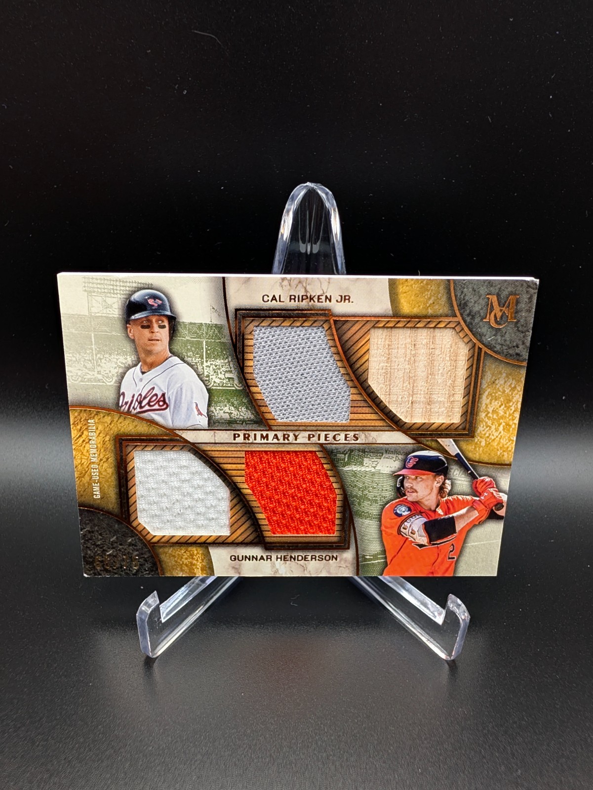 Cal Ripken Jr. & Gunnar Henderson Primary Pieces Quad Relic Quad Relic - Trading Card Image