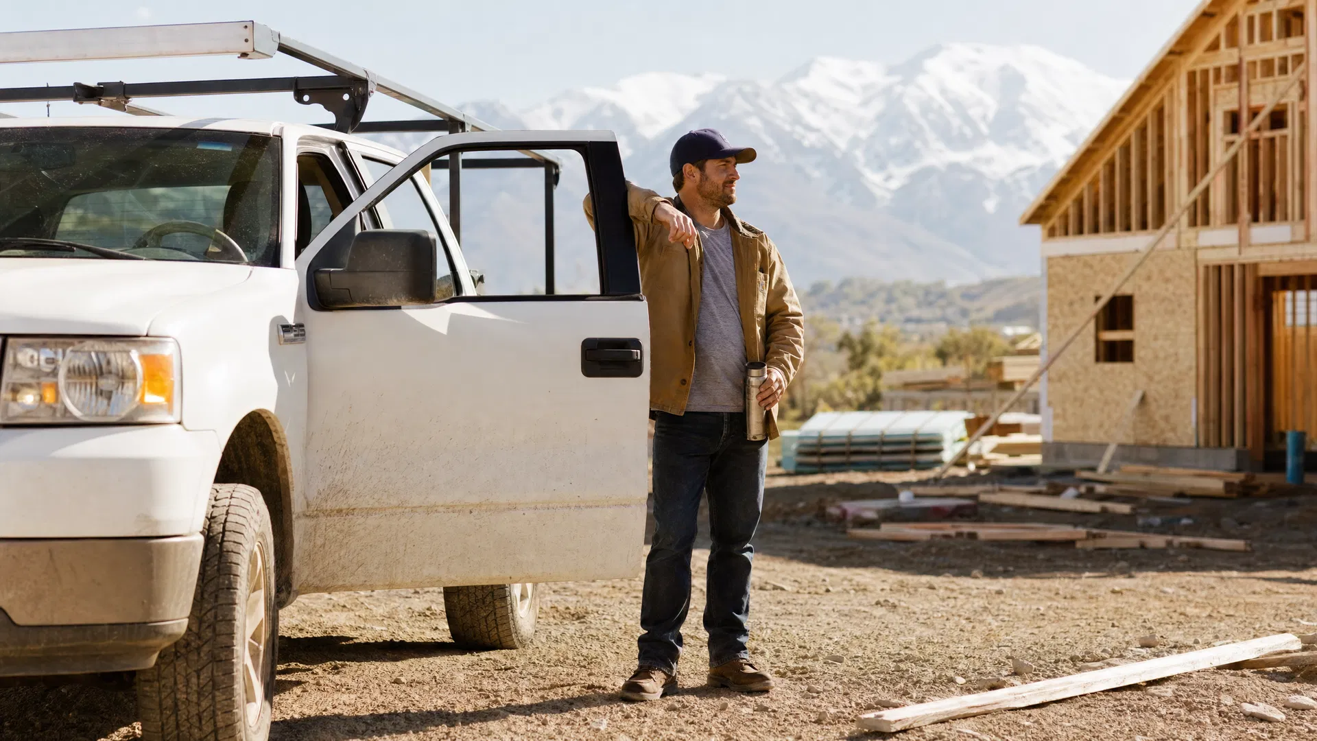Utah tradesman beside his work truck with the Wasatch Range behind him