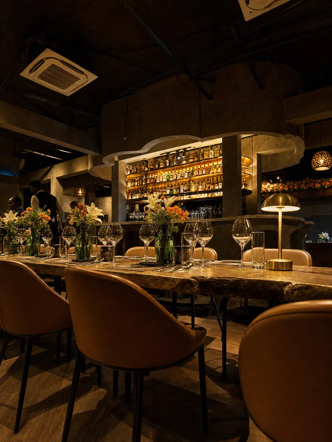 Intimate table setting with bar glow and live-edge tables