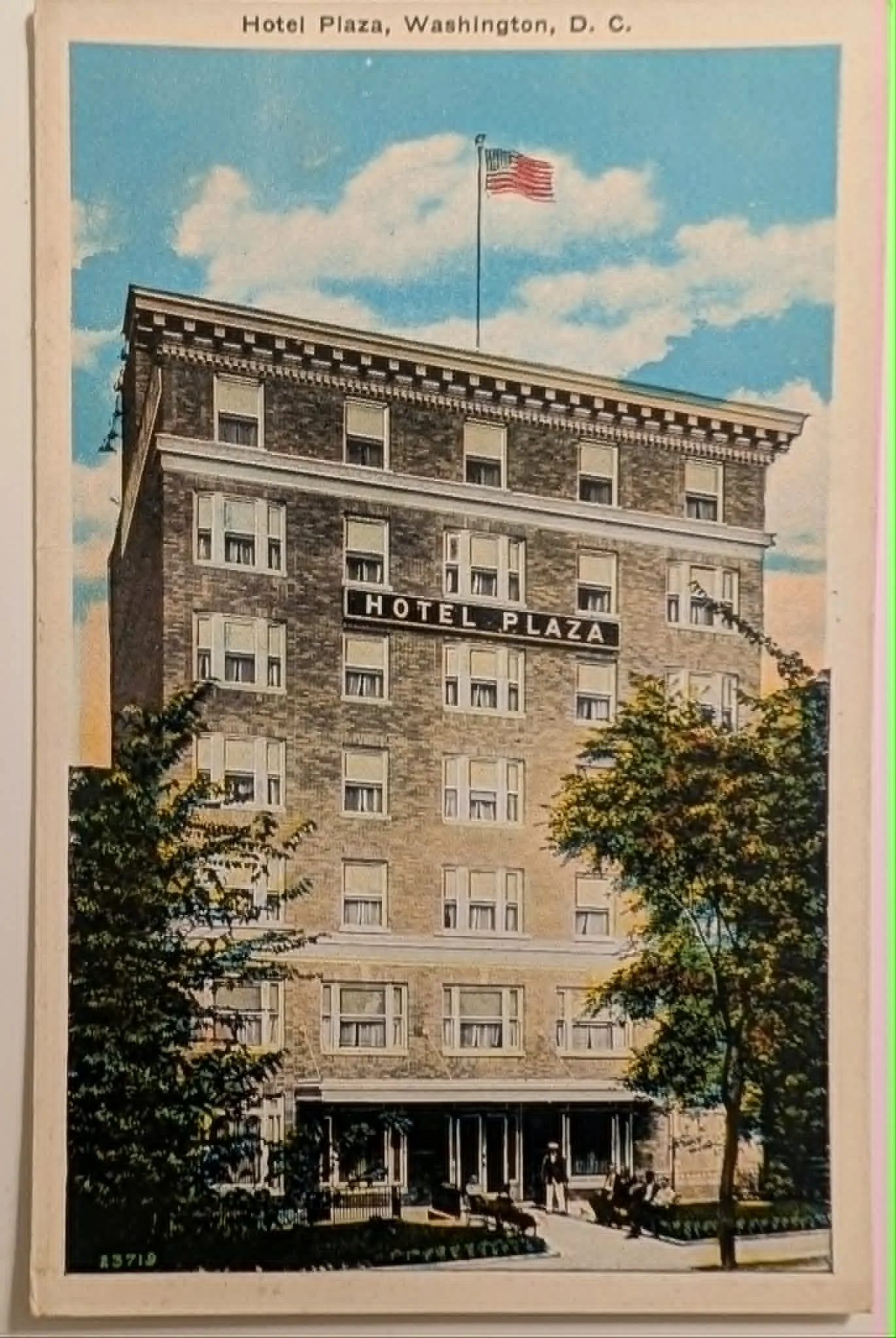 A vertical vintage postcard showing the Hotel Plaza in Washington, D.C. The image features a towering brown brick hotel against a bright blue sky with white clouds. An American flag flies from a pole on the roof. A sign on the facade reads "HOTEL PLAZA." Green trees flank the building, and people are seated on a bench near the entrance. The top border reads "Hotel Plaza, Washington, D. C." and the reverse side features blue printed text detailing the hotel's amenities, a publisher credit to B. S. Reynolds Co., and a stylized 'M' logo.