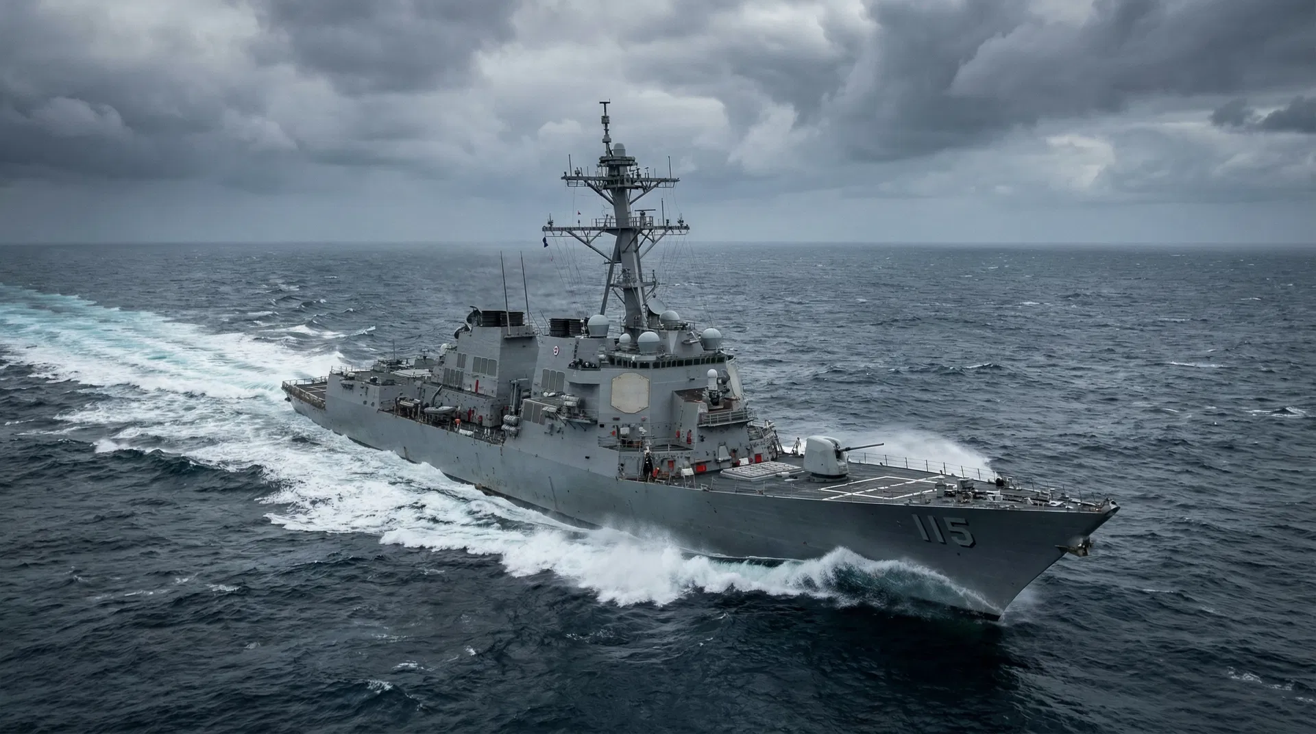 US Navy destroyer cutting through ocean waves