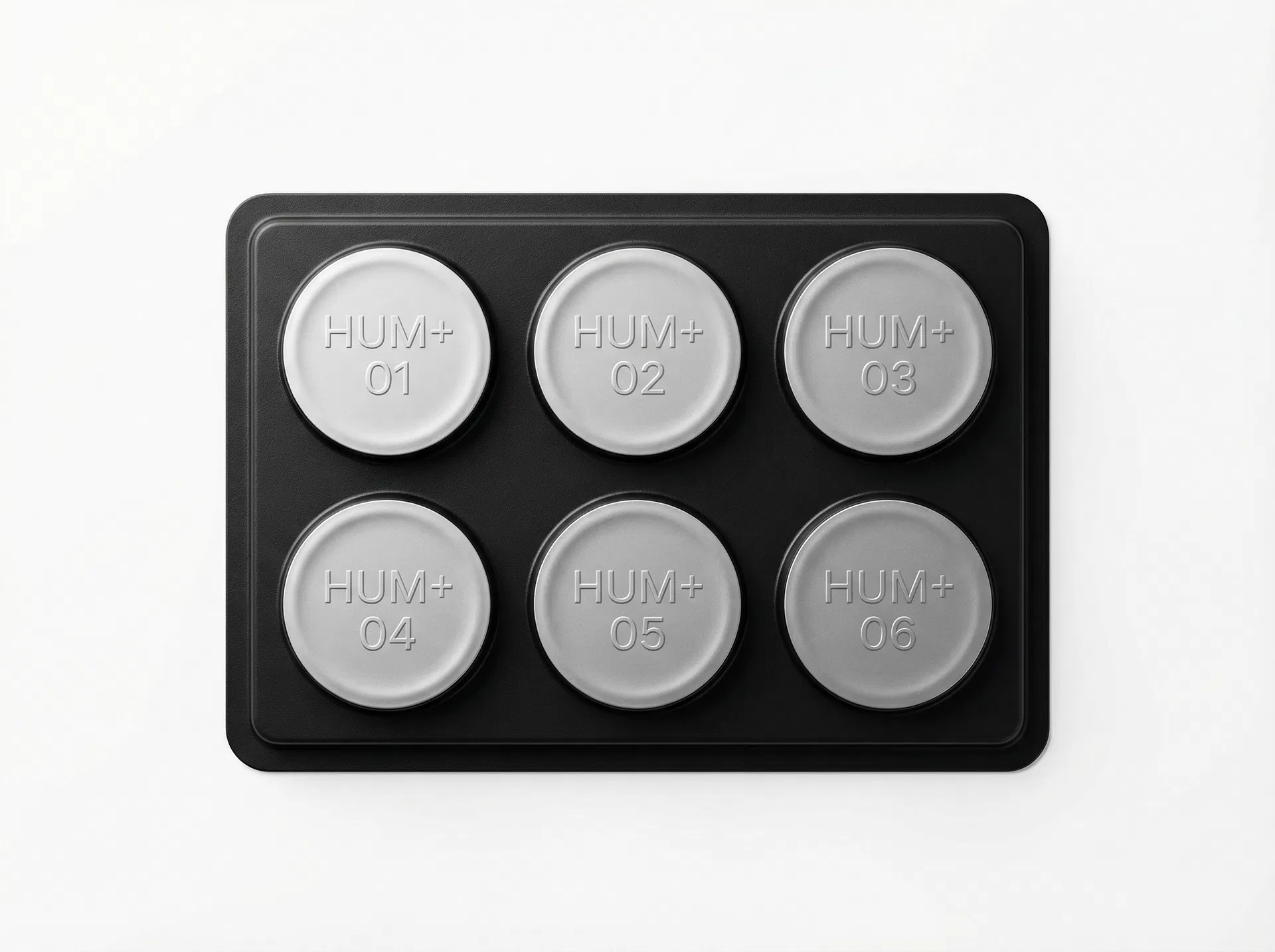 HUM+ six-dose pharmaceutical blister tray — matte black medical packaging