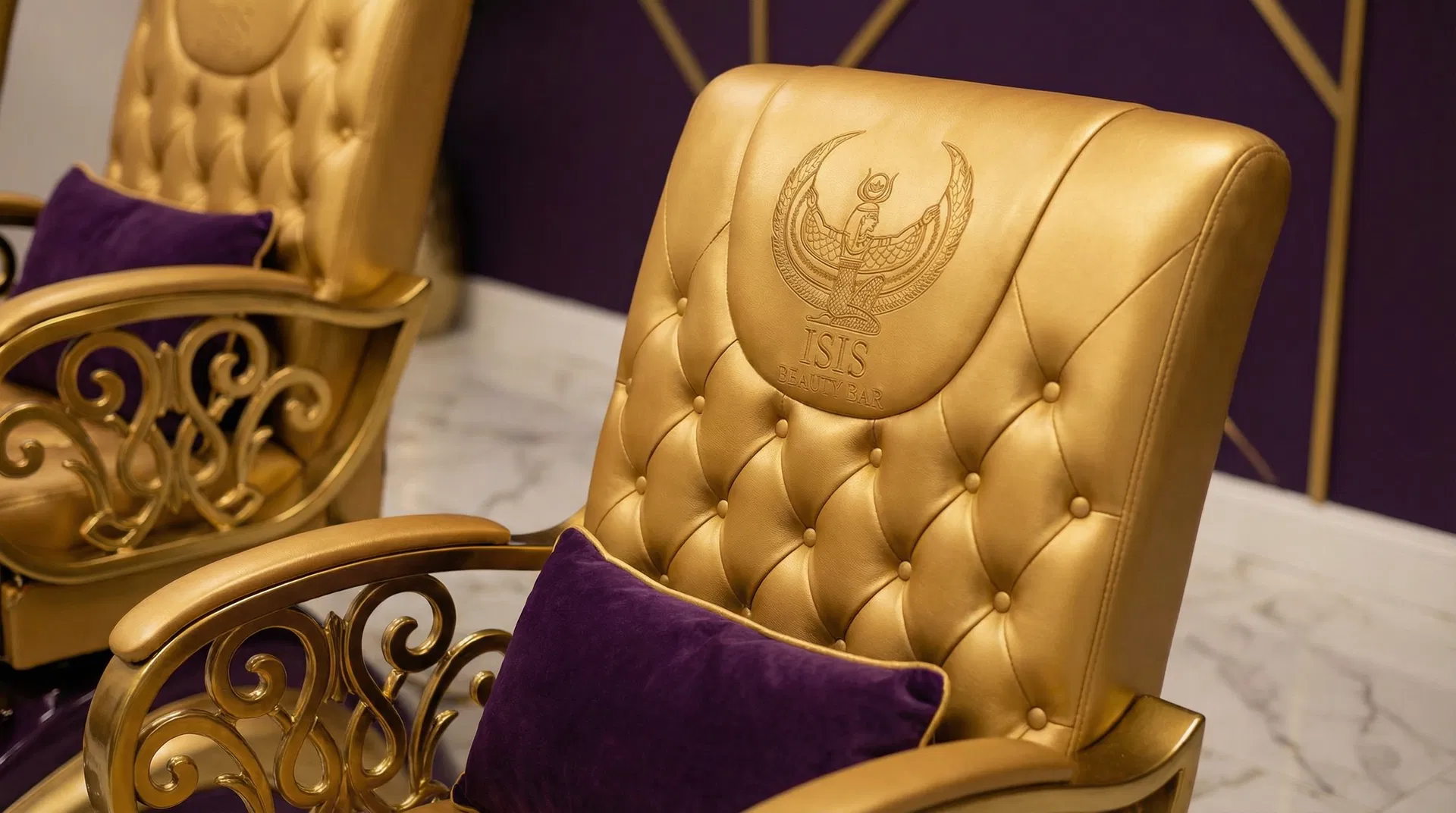 Custom gold-tufted branded pedicure chair with Isis Beauty Bar embossed logo