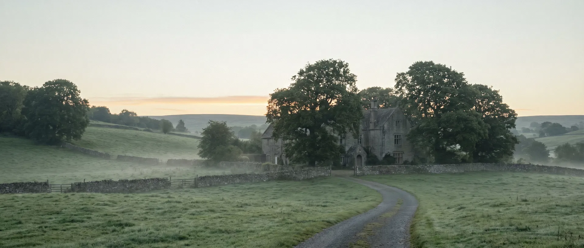 An English country estate at dawn, mist over the meadow.