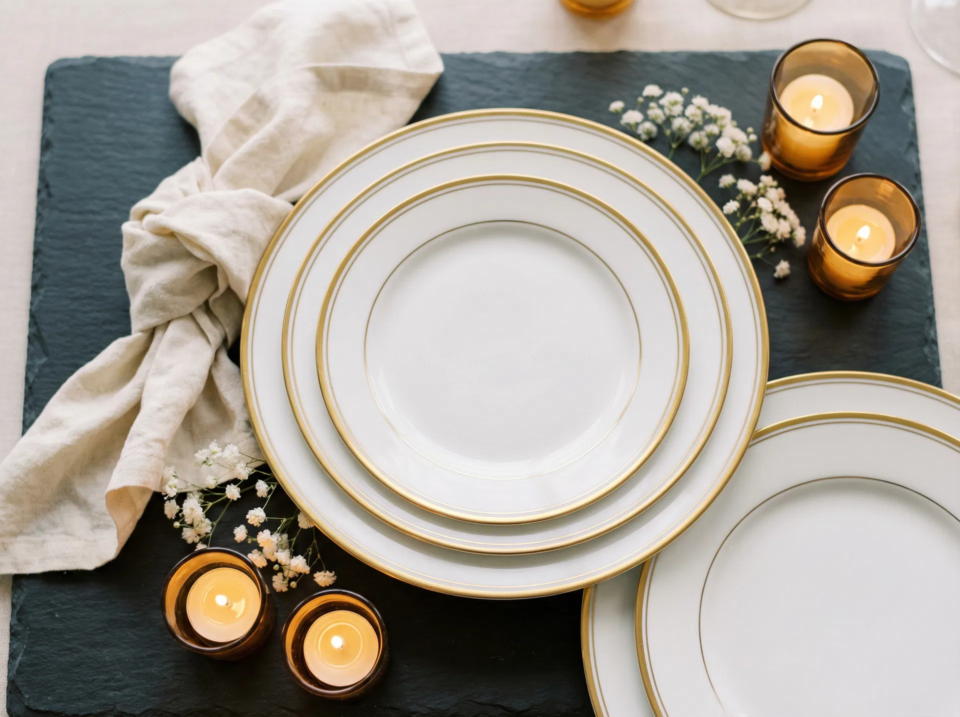 Elegant white china dinner plates with gold rim for event rental in Utah