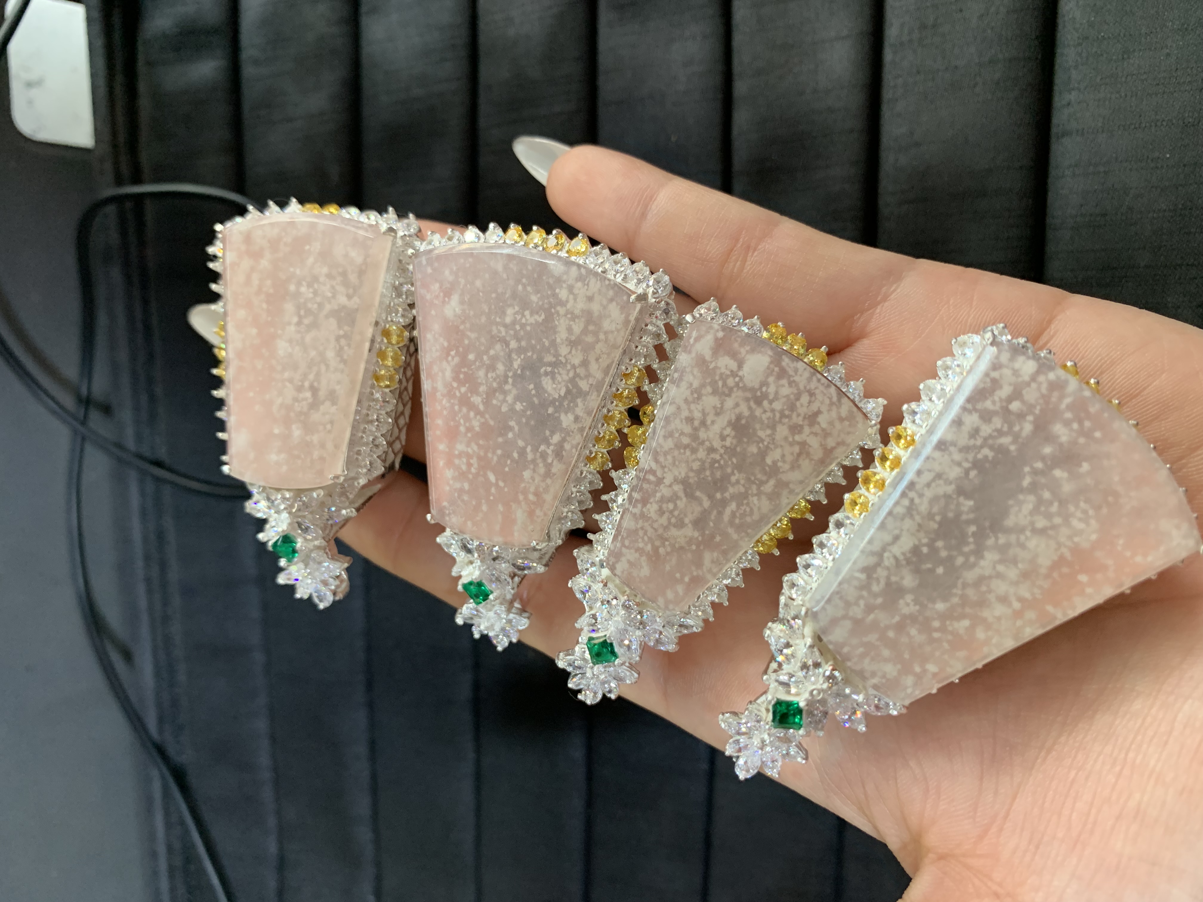 Collection of Pink Speckled Gem Pendants with Embellished Settings 