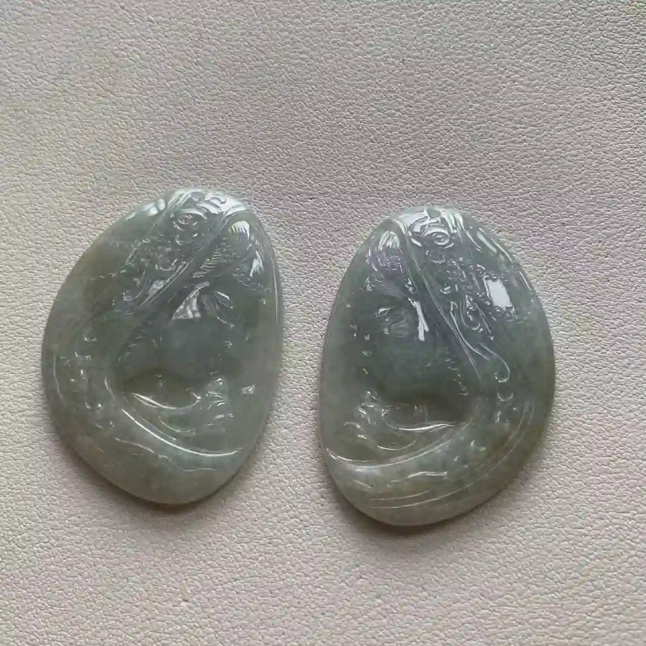   Pair of Icy Green Jade Pendants with Guanyin & Fish Carvings, view 2 | Myanmar Jadeite reference #2040020