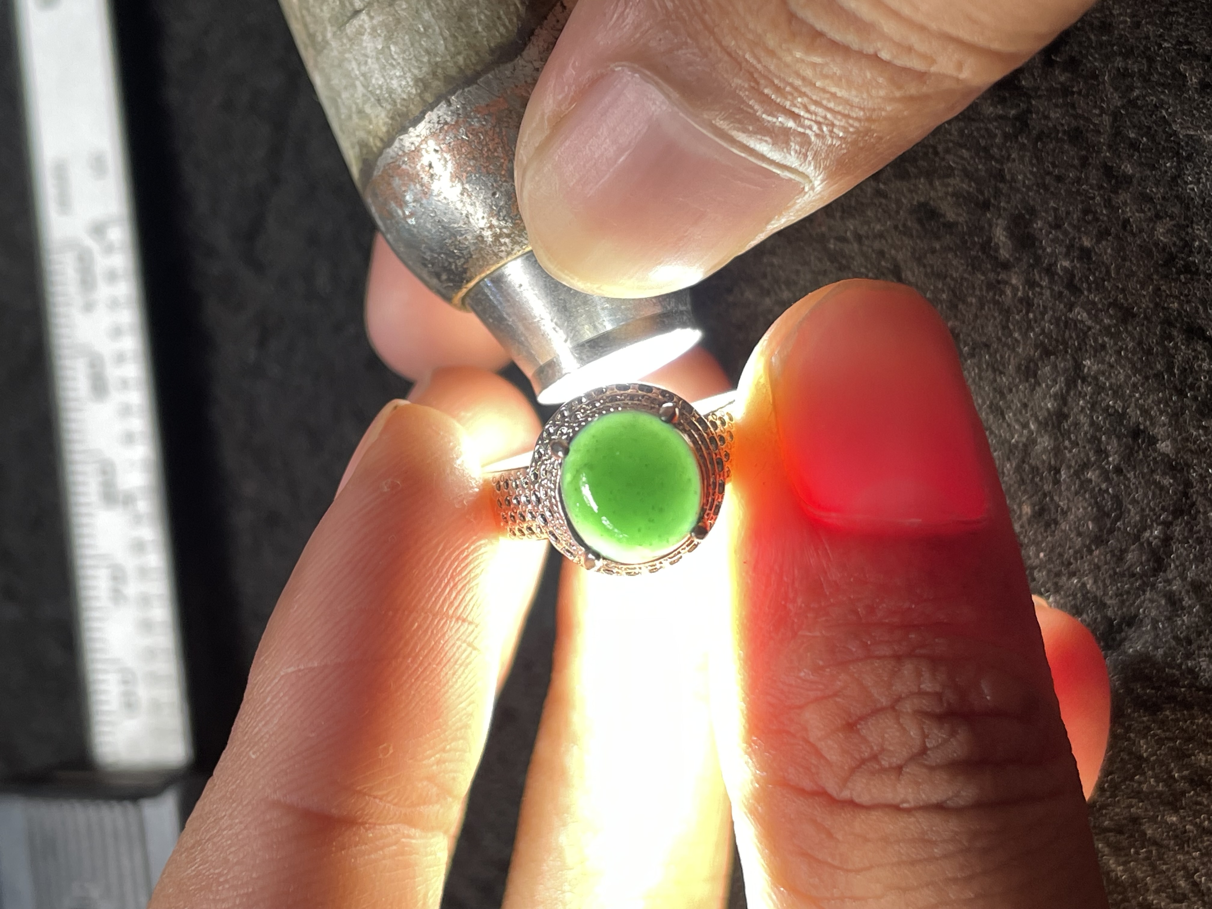 Vivid Green Jade Ring Under Light Inspection