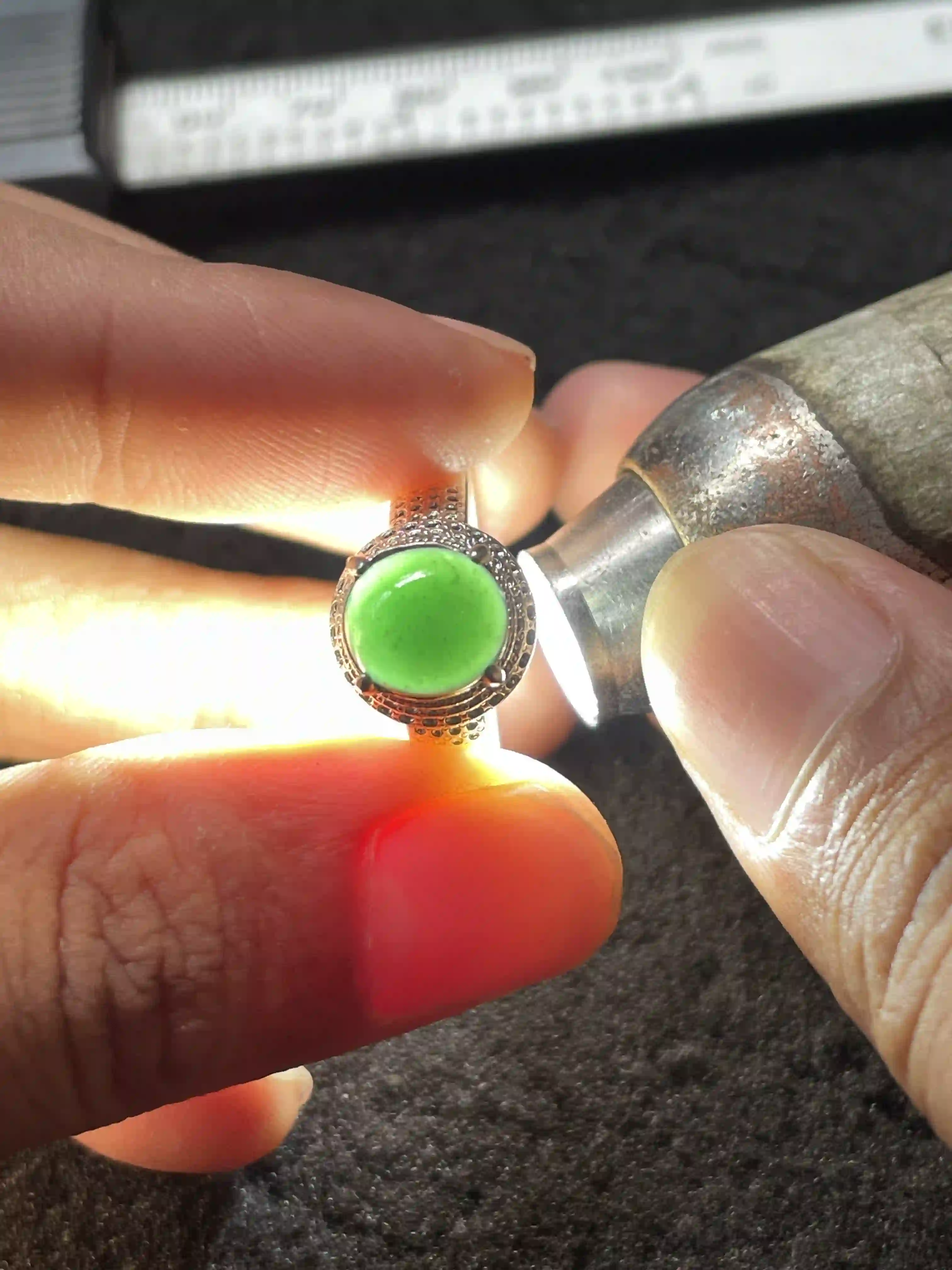 Vivid Green Jade Ring Under Light Inspection, view 2 | Myanmar Jadeite reference #660001