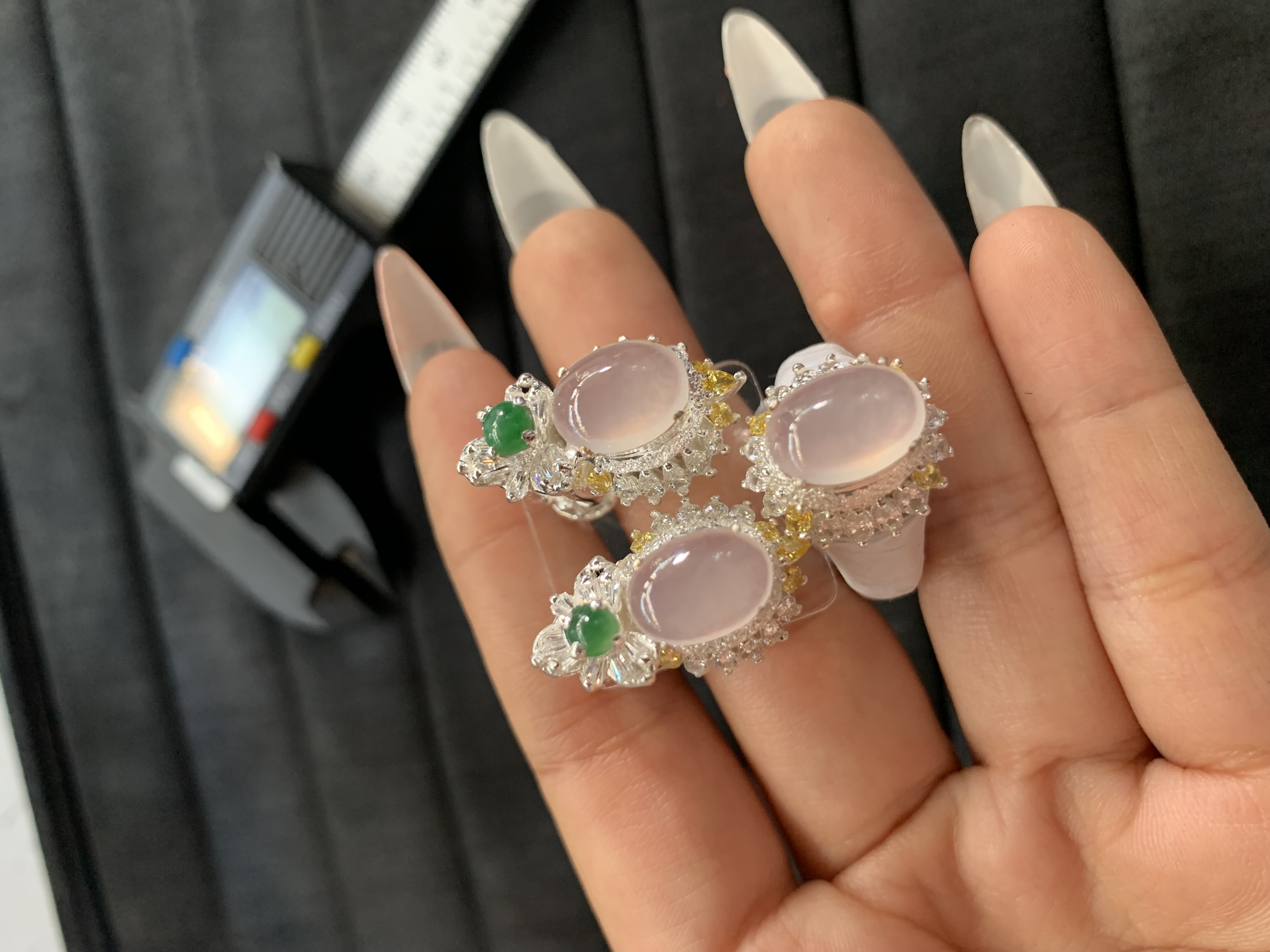 Elegant Pink Gemstone Rings with Green Accents and Sparkling Detailing