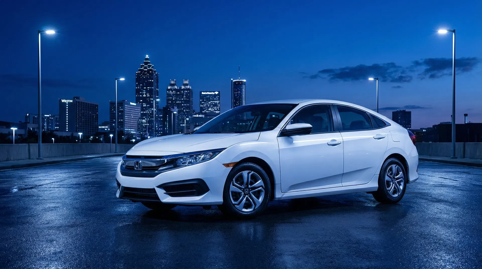 Economy rental car against the Atlanta skyline at blue hour