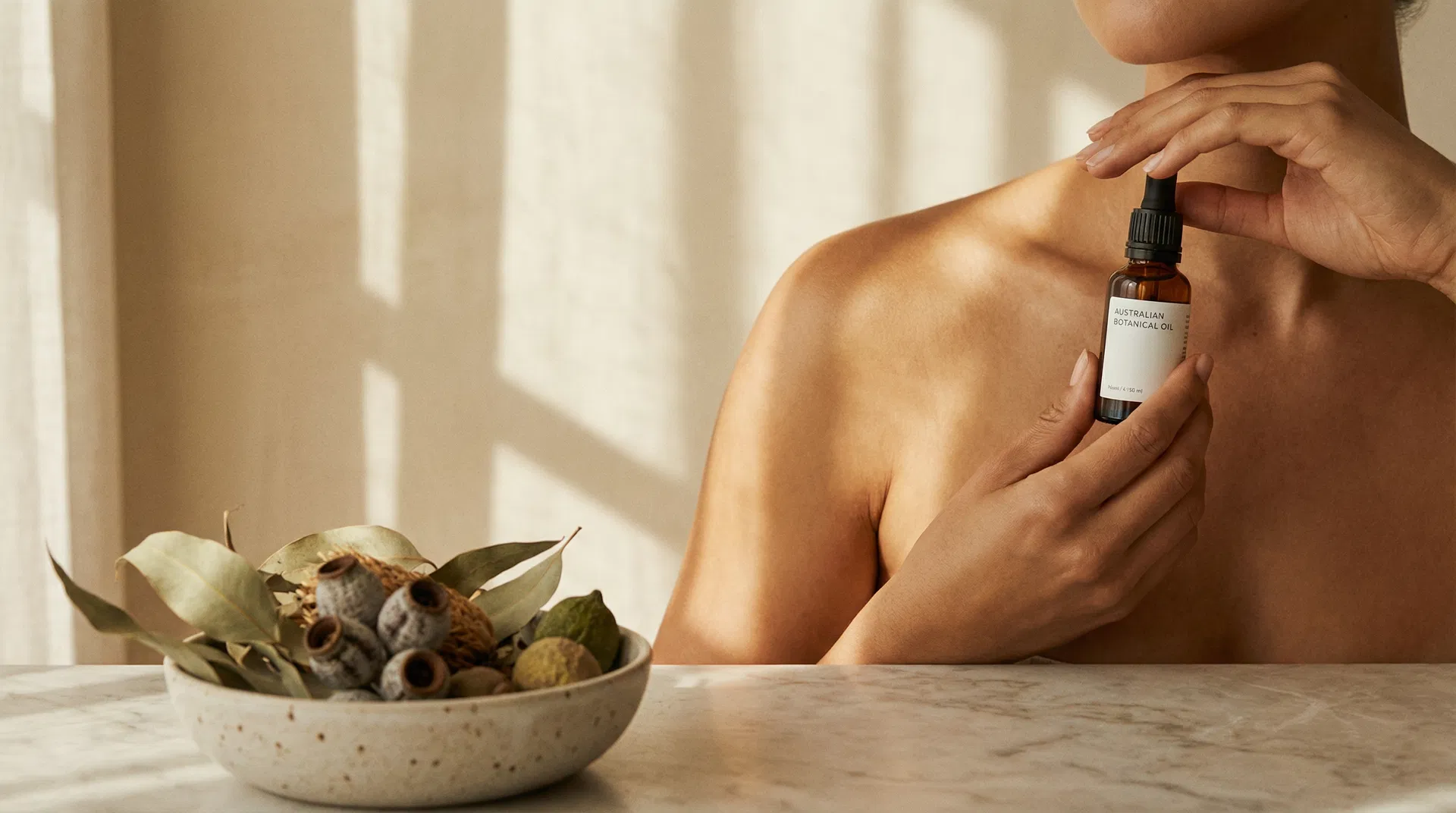 Woman applying Reni Oils botanical oil