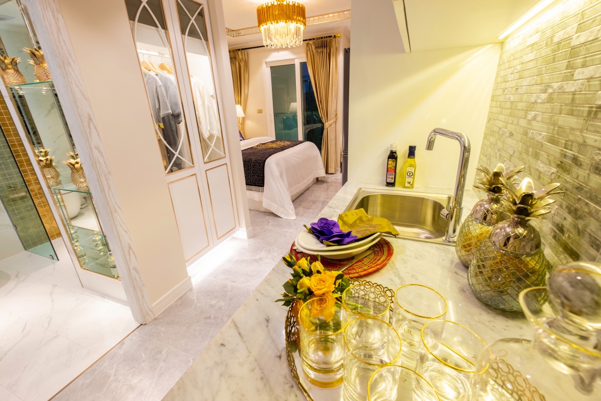 Studio Condo for Sale at Seven Seas Le Carnival: Kitchen counter with sink, decorative pineapples, and glasses.