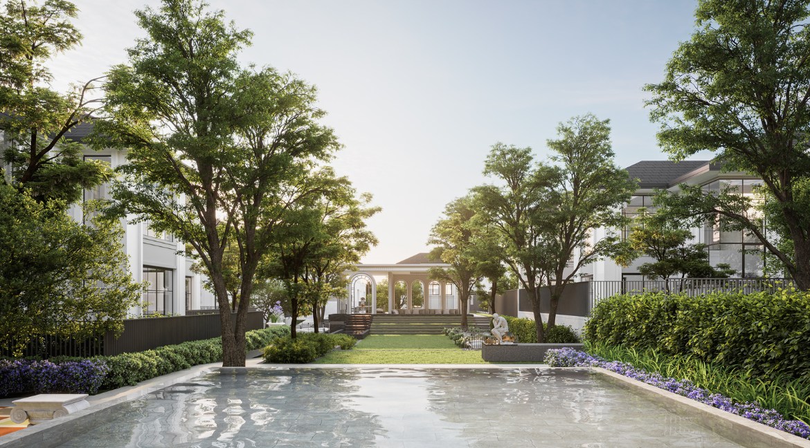 RAKHA PATTAYA beautiful green garden with a reflective pool, lush trees, and a distant gazebo.