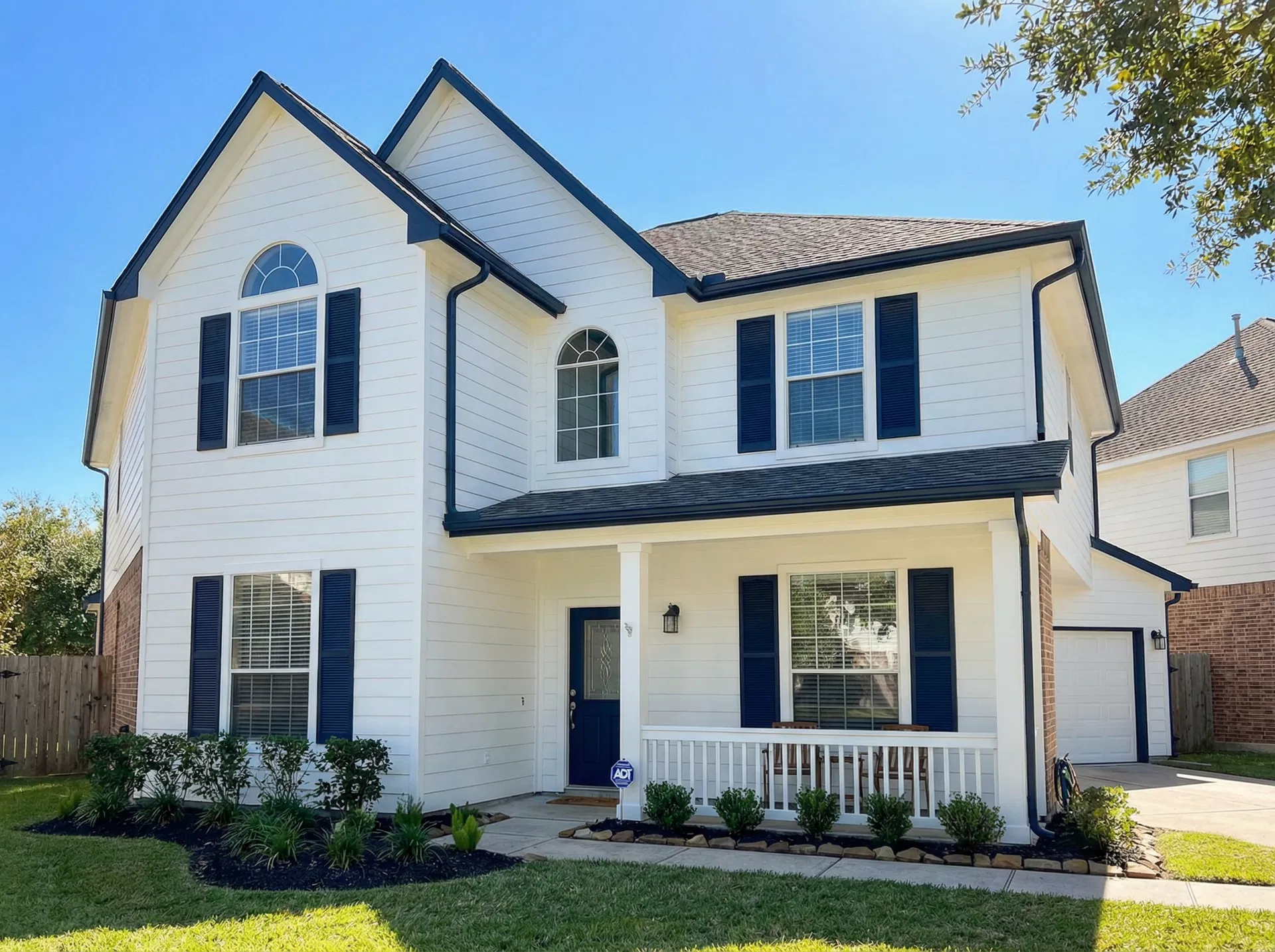 Houston home exterior after Wise Pro Painting — fresh crisp white paint with navy trim