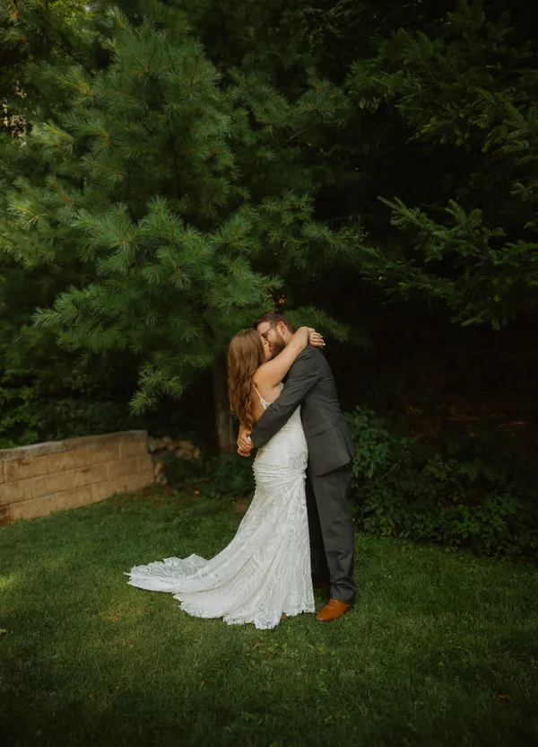 Bride and groom embracing and sharing a kiss