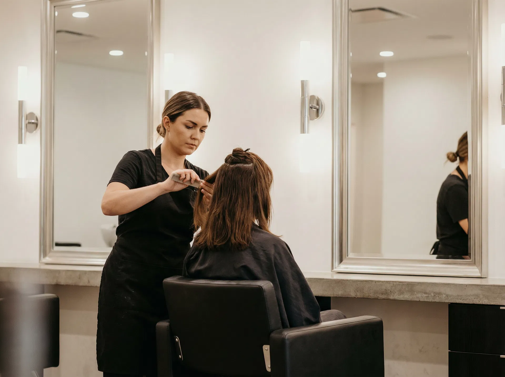 Professional stylist working on client — Level Salon Port Washington