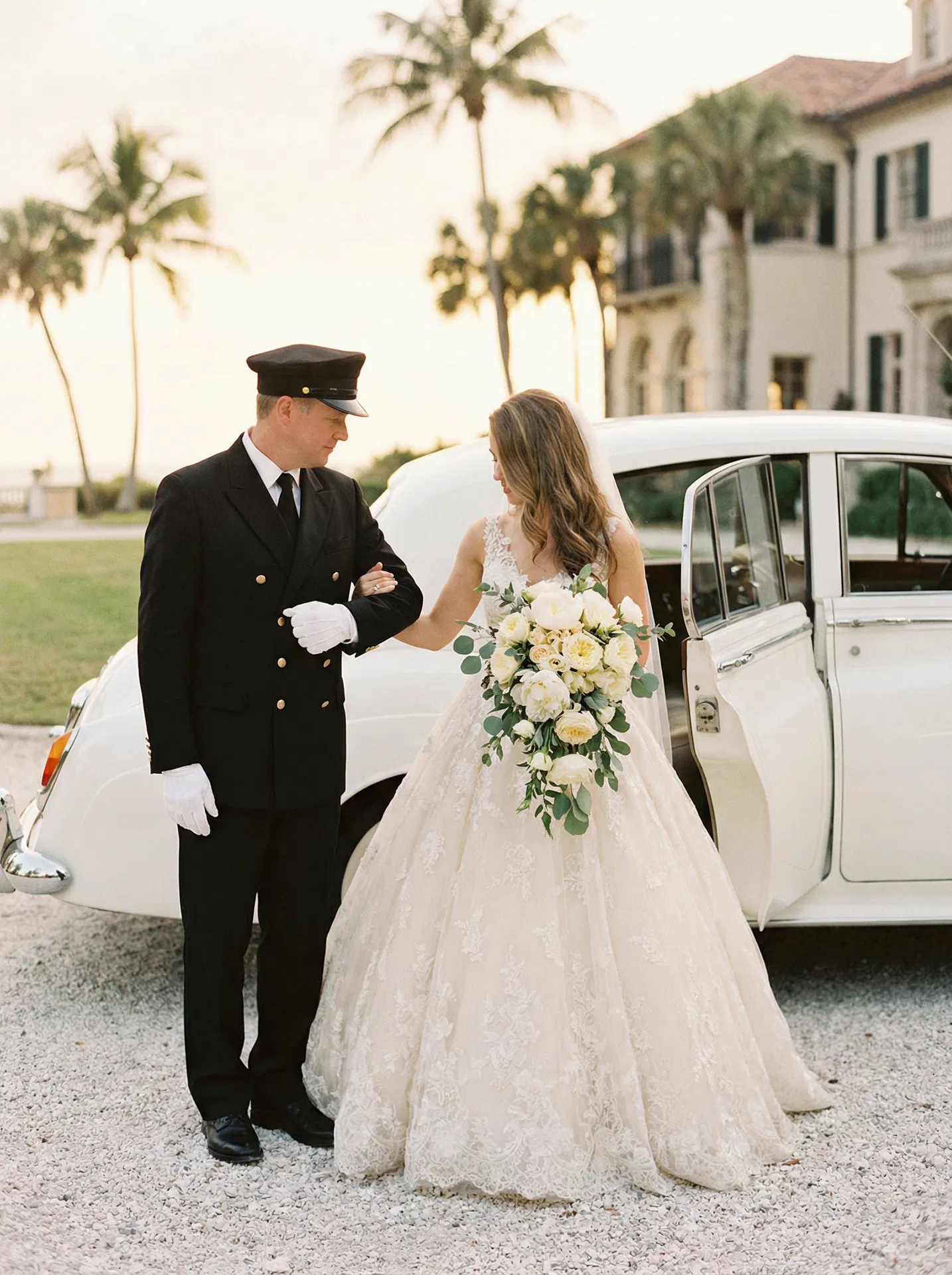 Chauffeur assisting bride at luxury Florida estate