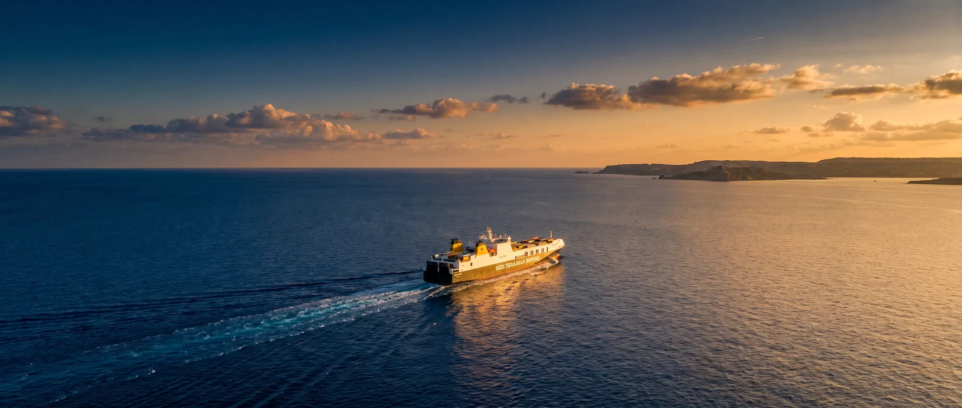 Cargo vessel crossing the Mediterranean at sunset