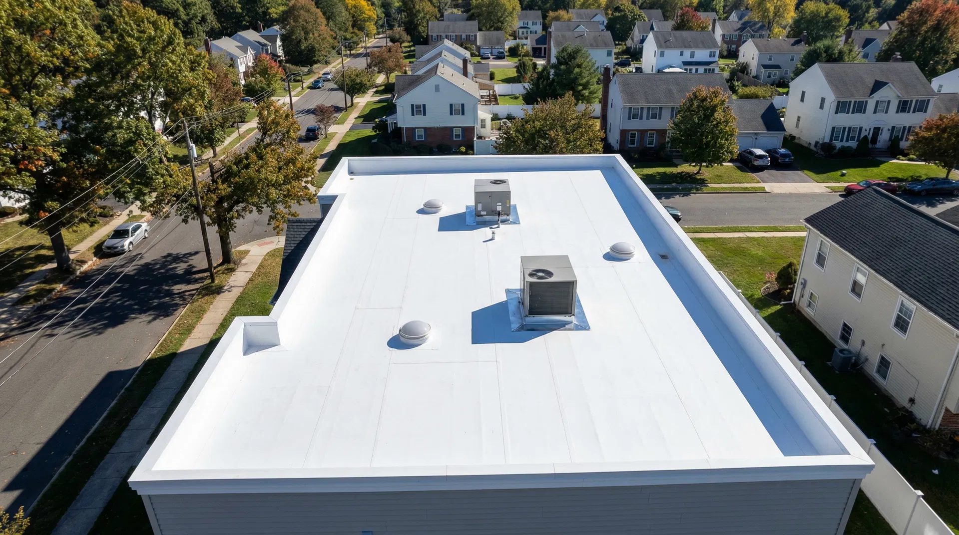 Aerial view of completed residential flat roof replacement in Phillipsburg, NJ — white TPO membrane with clean seams and proper drainage