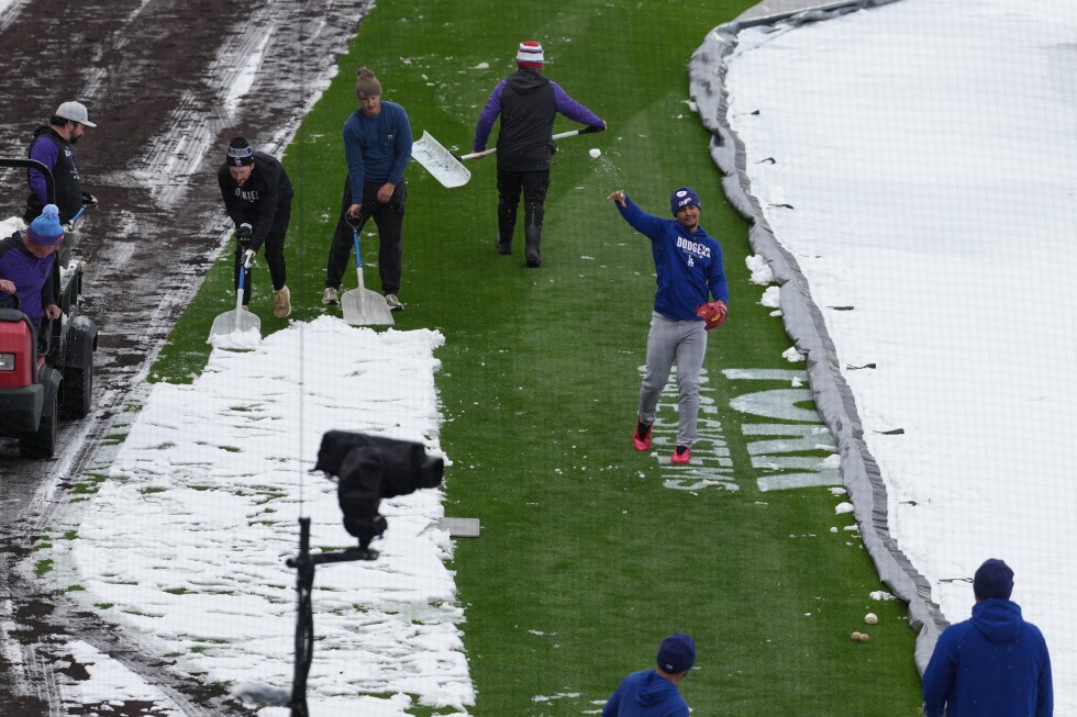 A mid-April snowstorm coats Coors Field as Dodgers-Rockies series gets off to frosty start - AP News