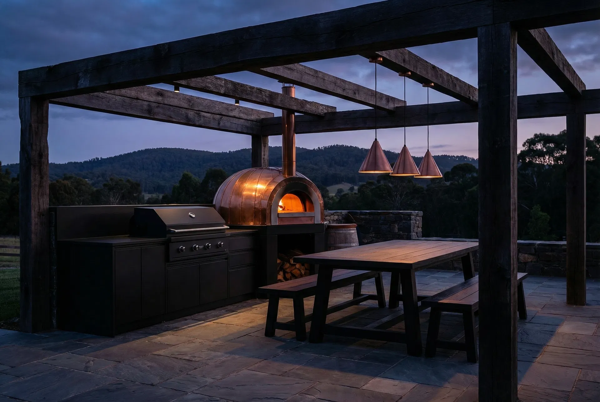 Outdoor kitchen with copper pizza oven