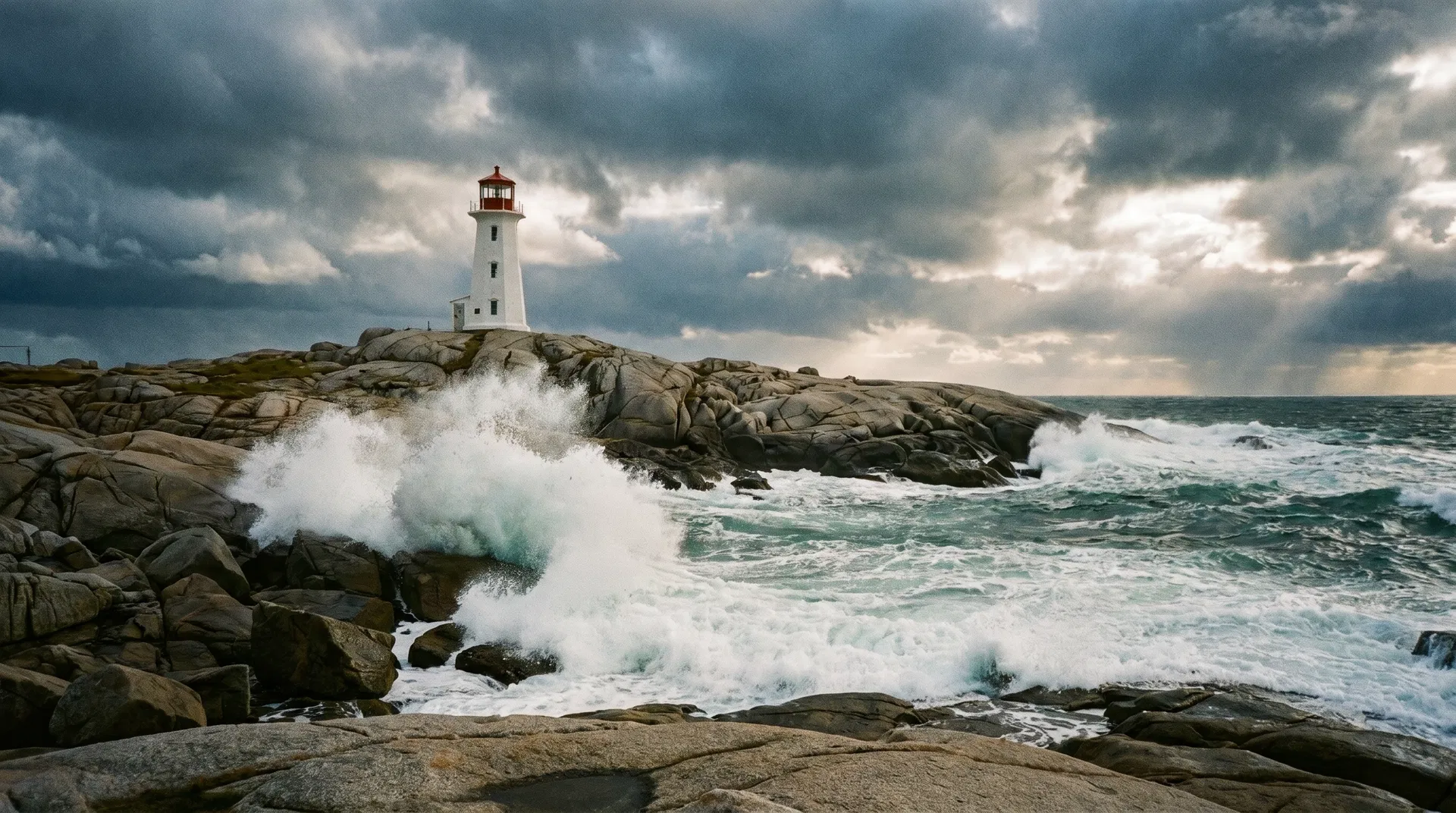 Peggy's Cove lighthouse in Nova Scotia with waves crashing on granite rocks