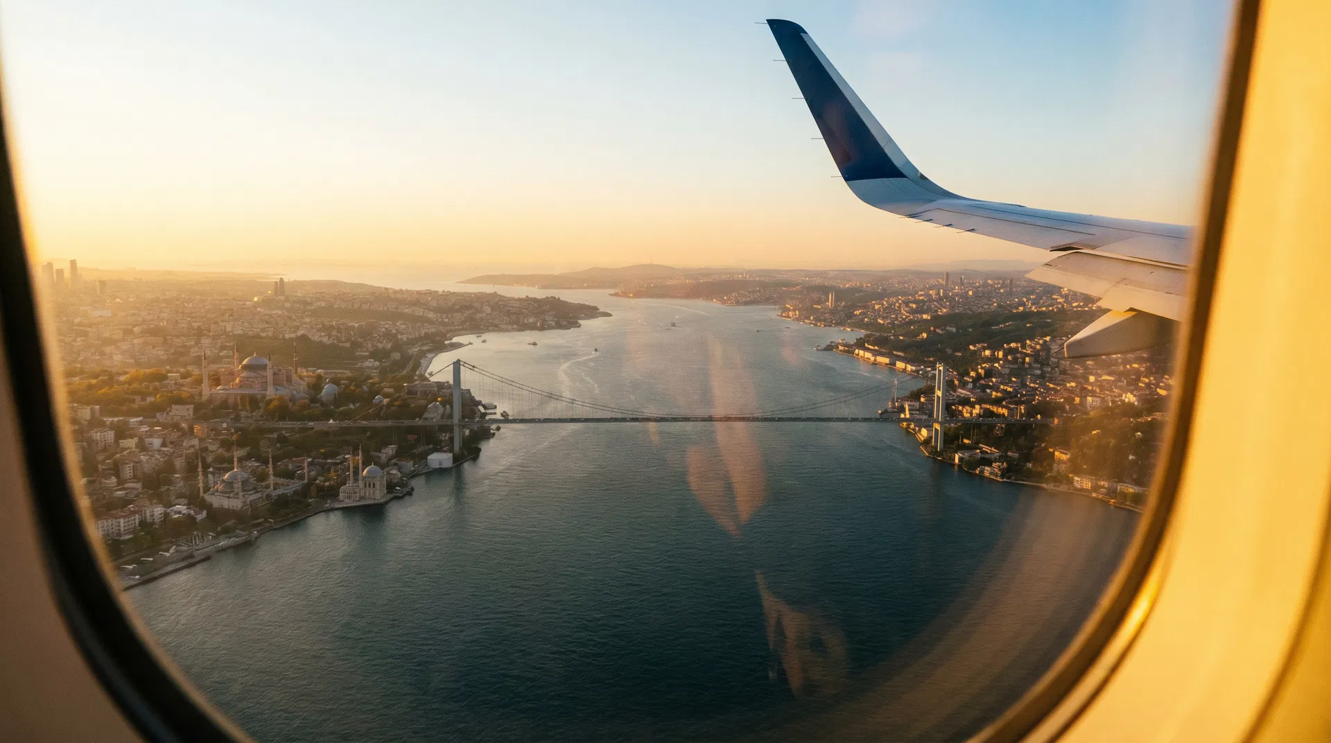 View from airplane window showing Istanbul coastline and Bosphorus Bridge