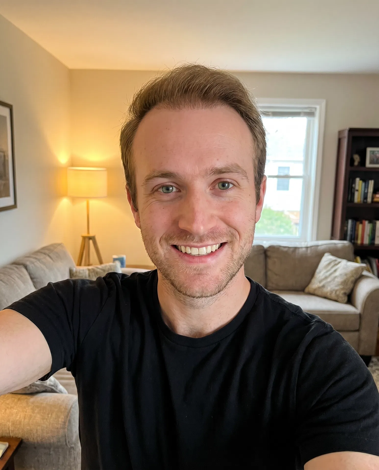 After hair transplant — happy selfie at home with full natural hair 12 months later