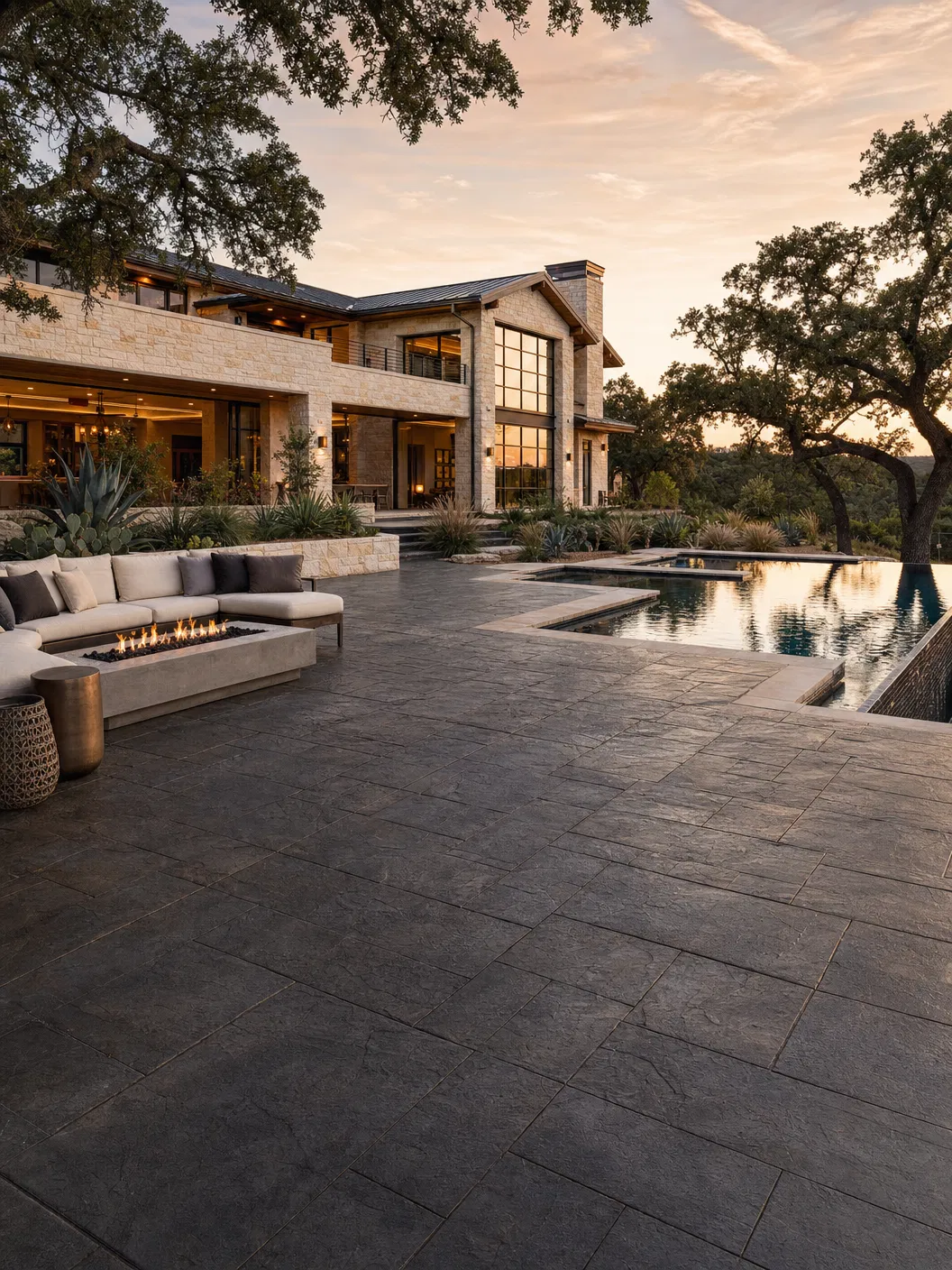 Luxury Austin home backyard with a freshly sealed stamped concrete patio at golden hour.