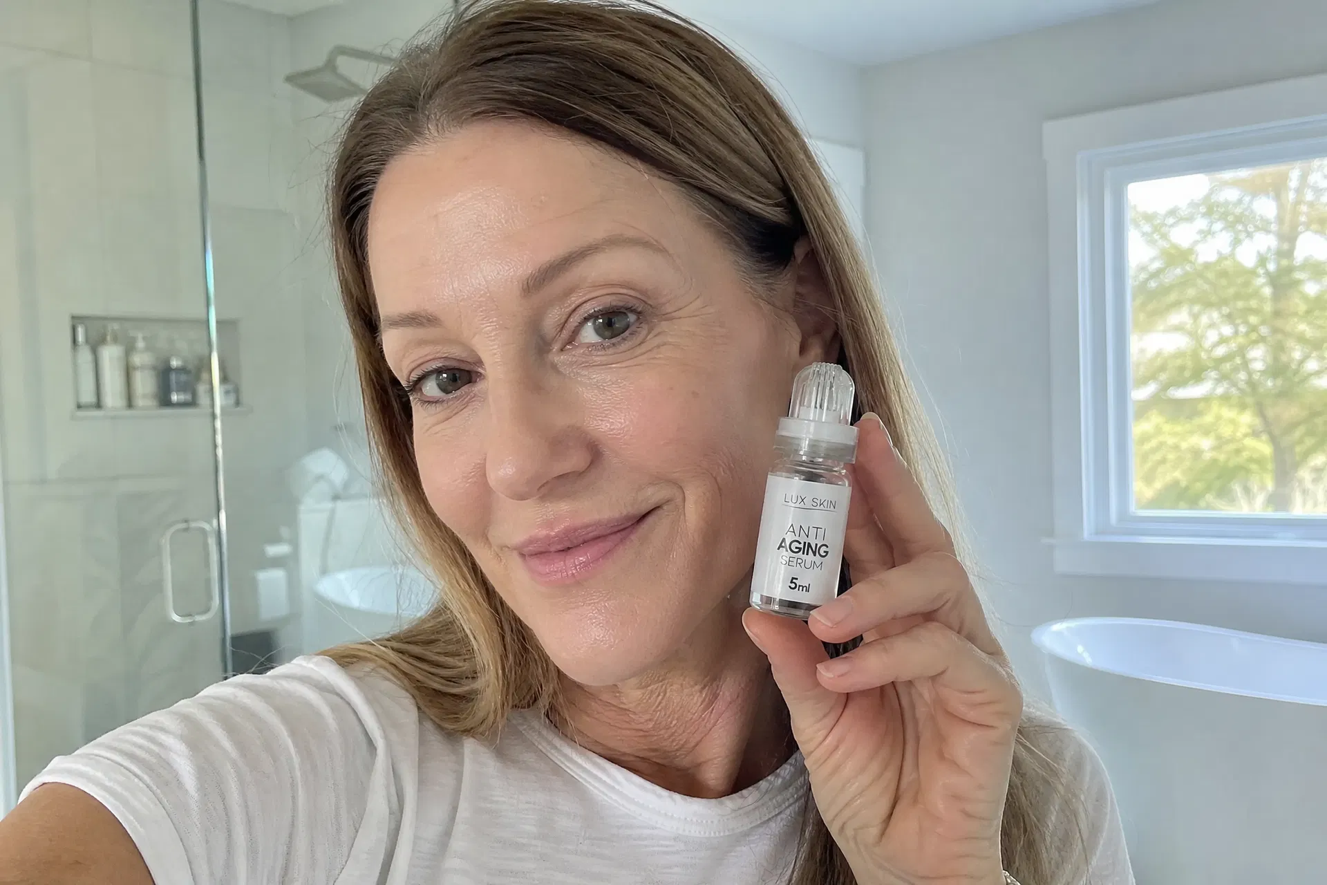 Woman holding LUX SKIN Anti Aging Micro Infusion Kit