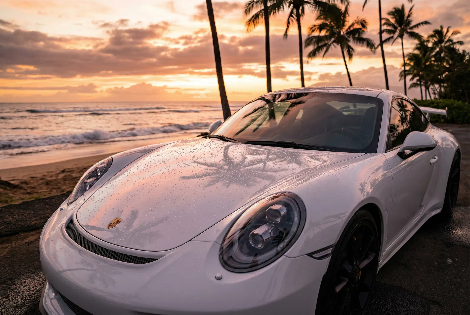 White Porsche 911 GT3 with ceramic coating at Hawaiian beachfront sunset