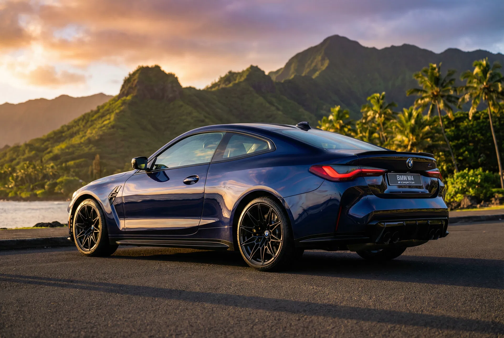 Dark blue BMW M4 Competition detailed with Hawaiian mountains backdrop